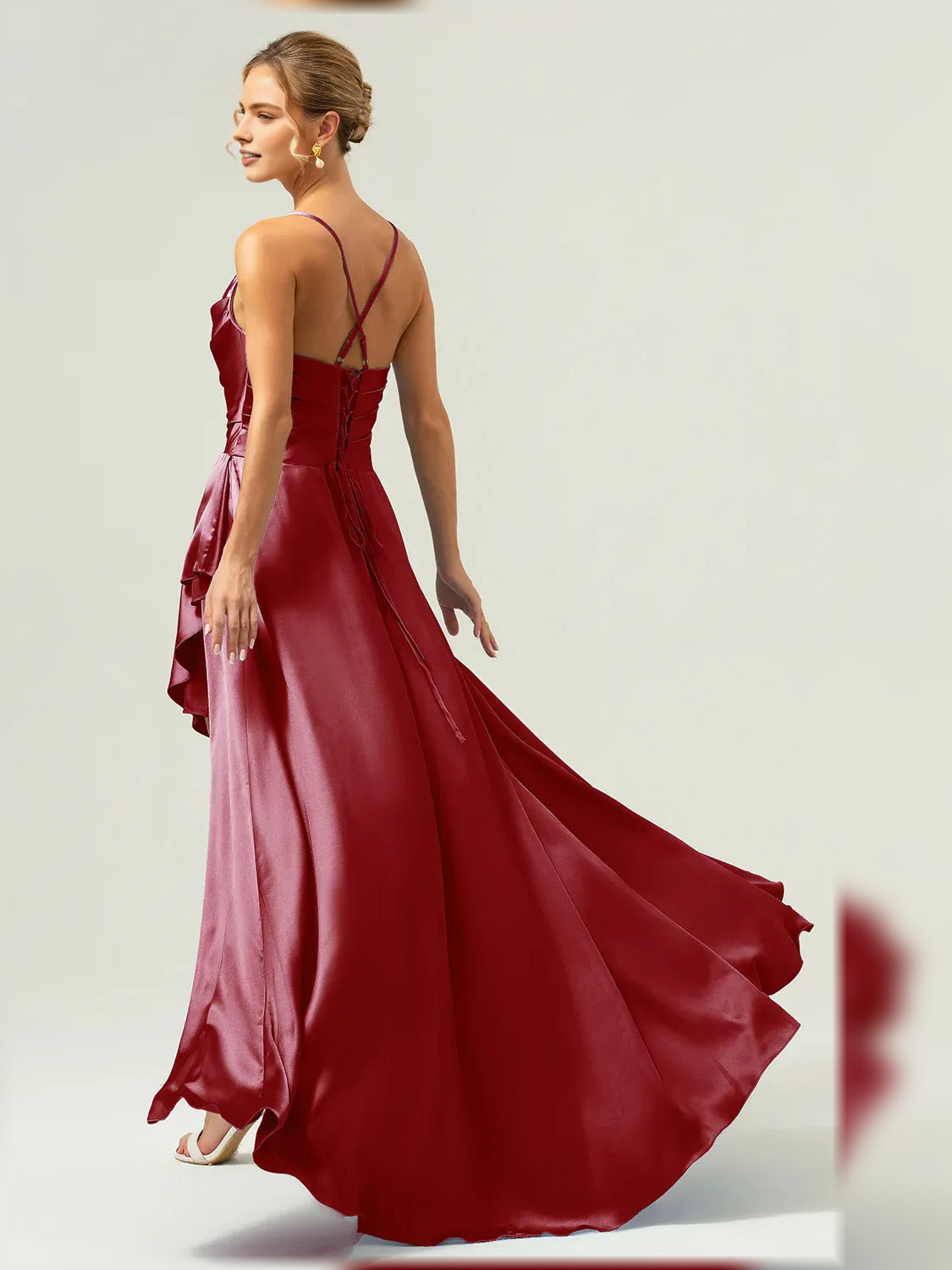 Burgundy formal satin maxi dress with cowl bodice, crisscross straps, and ruffle hem