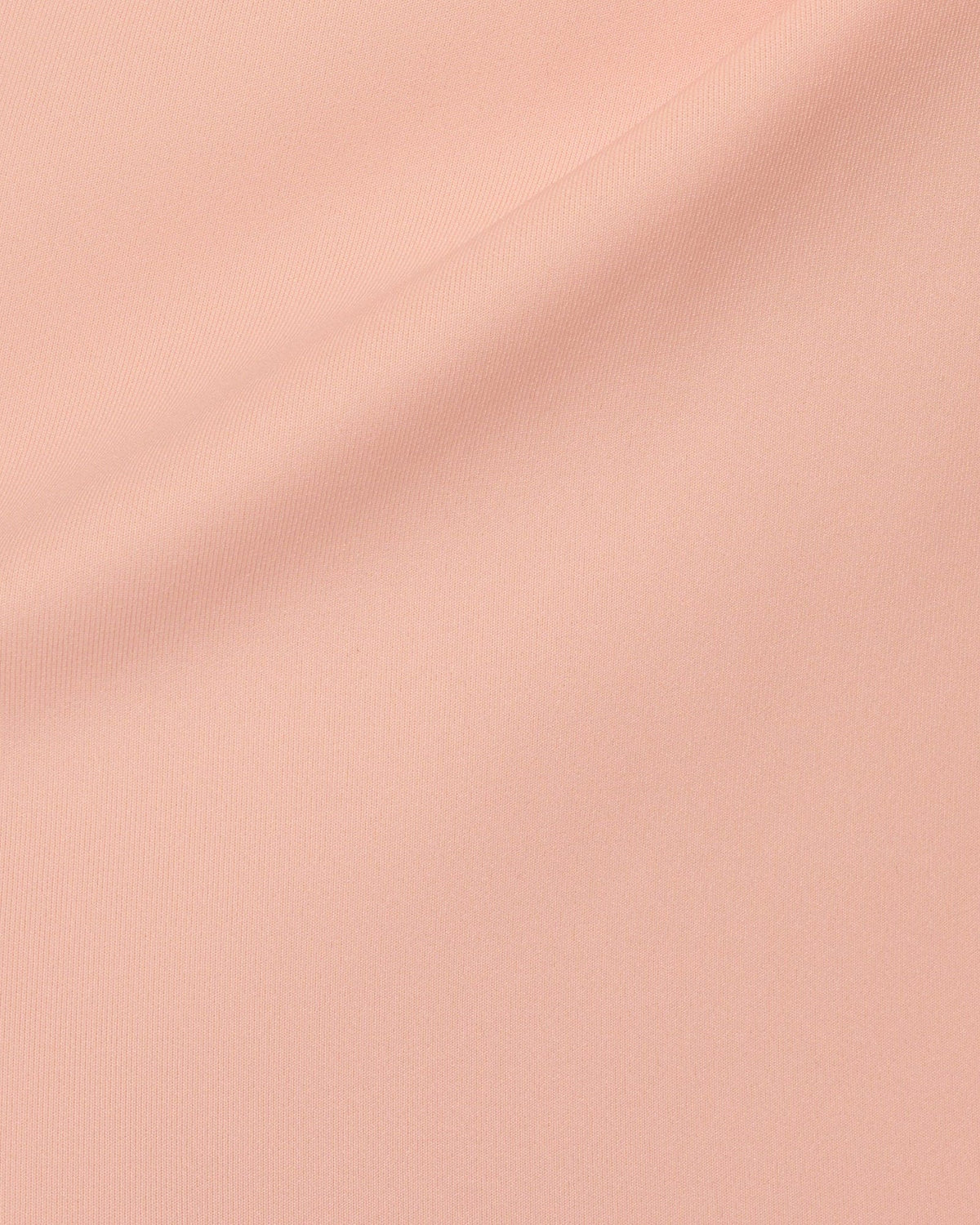 Pink textured fabric close-up with fine ribbed weave