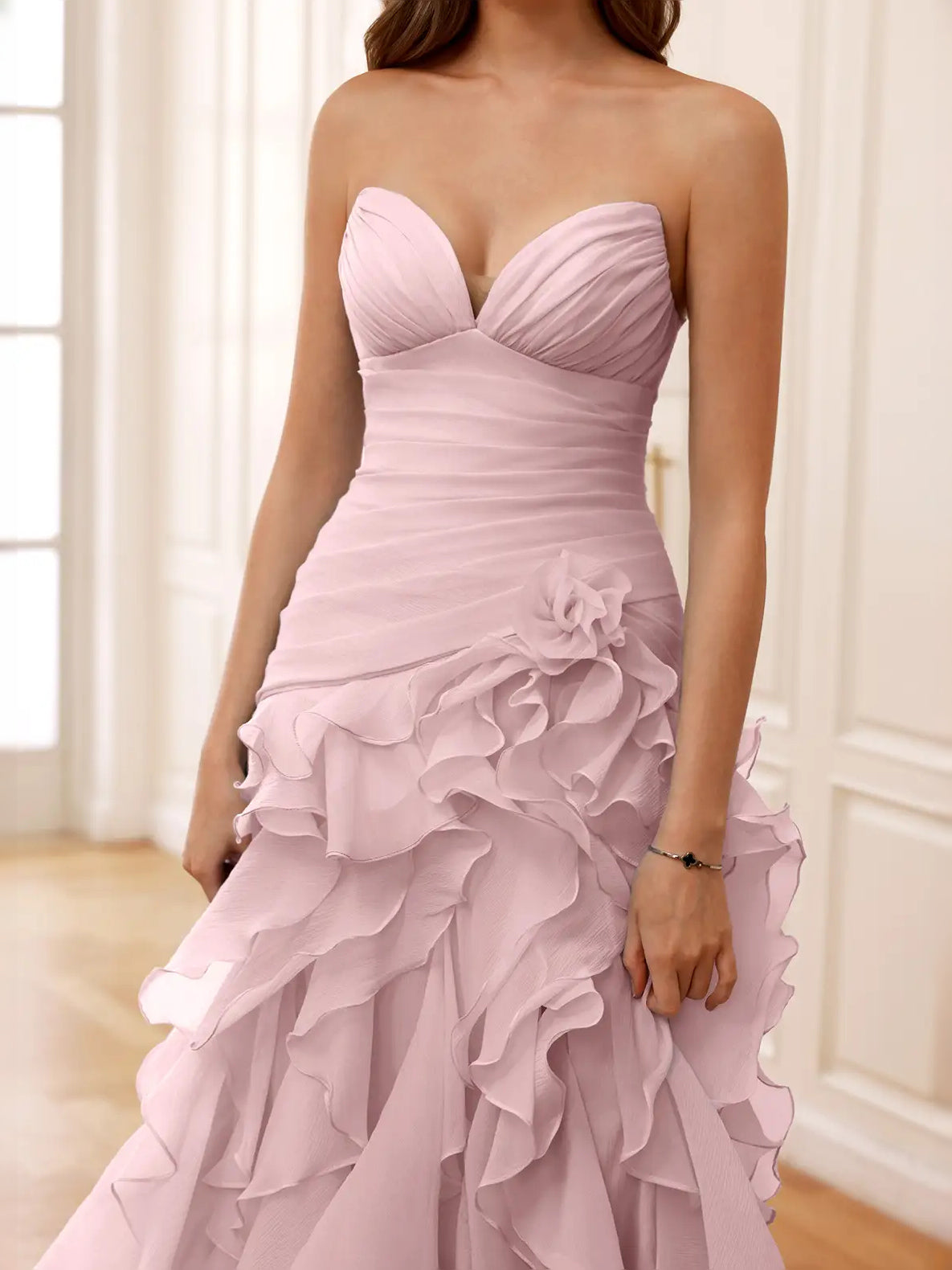 Dusty pink strapless sweetheart bodice with ruched waist and ruffled layered skirt