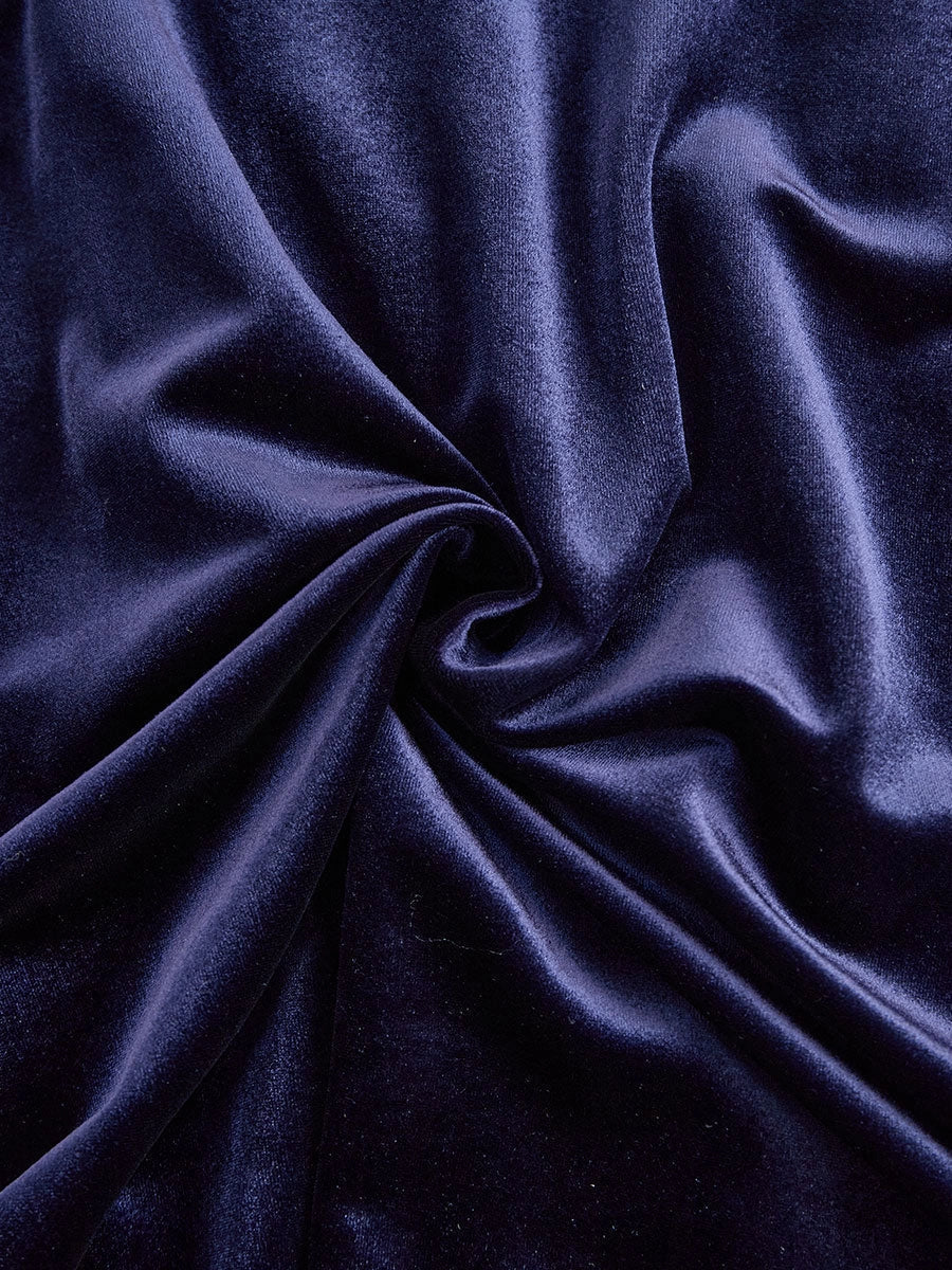Navy blue velvet fabric close-up with soft drape texture