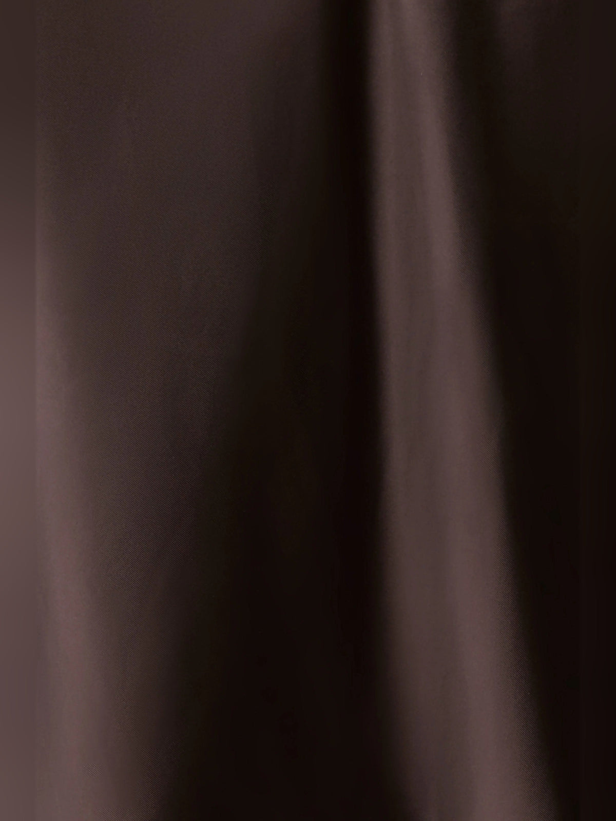 Chocolate satin-like fabric close-up with smooth drape texture