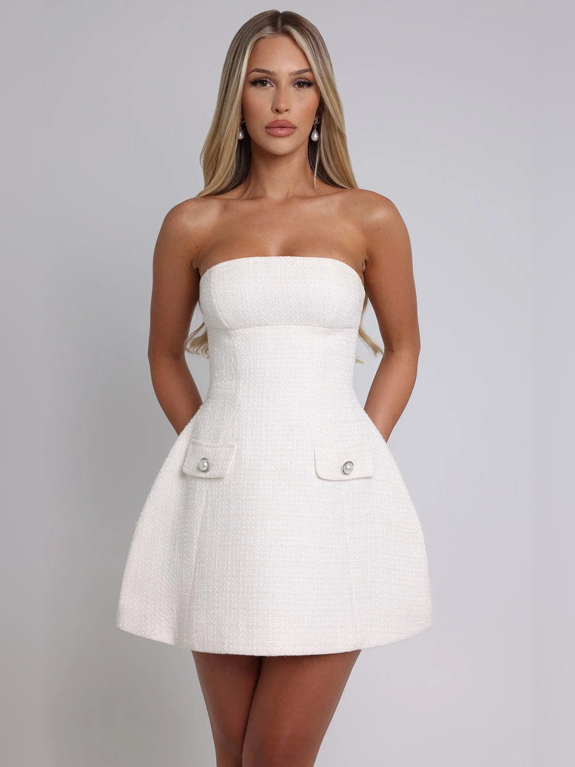 Ivory strapless mini dress with flared skirt and two front flap pockets