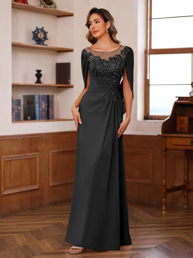Black floor-length sheath dress with floral lace bodice, sheer scoop neck, and side drape