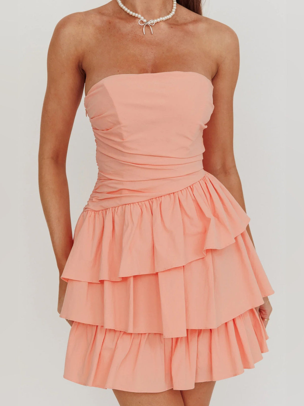 Coral strapless ruched bodice mini dress with layered ruffle skirt