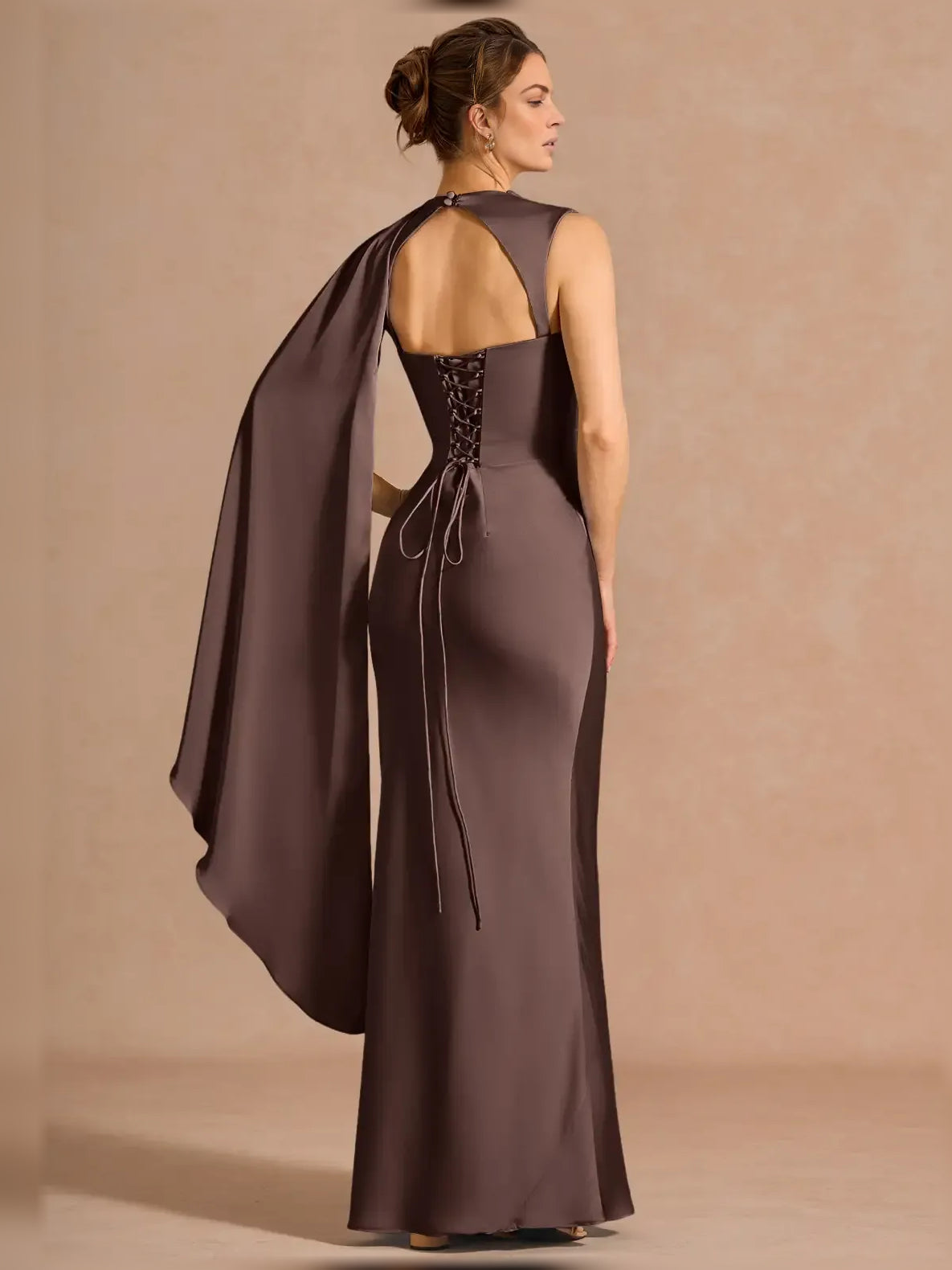 Espresso one-shoulder formal dress with open back and flowing draped cape panel