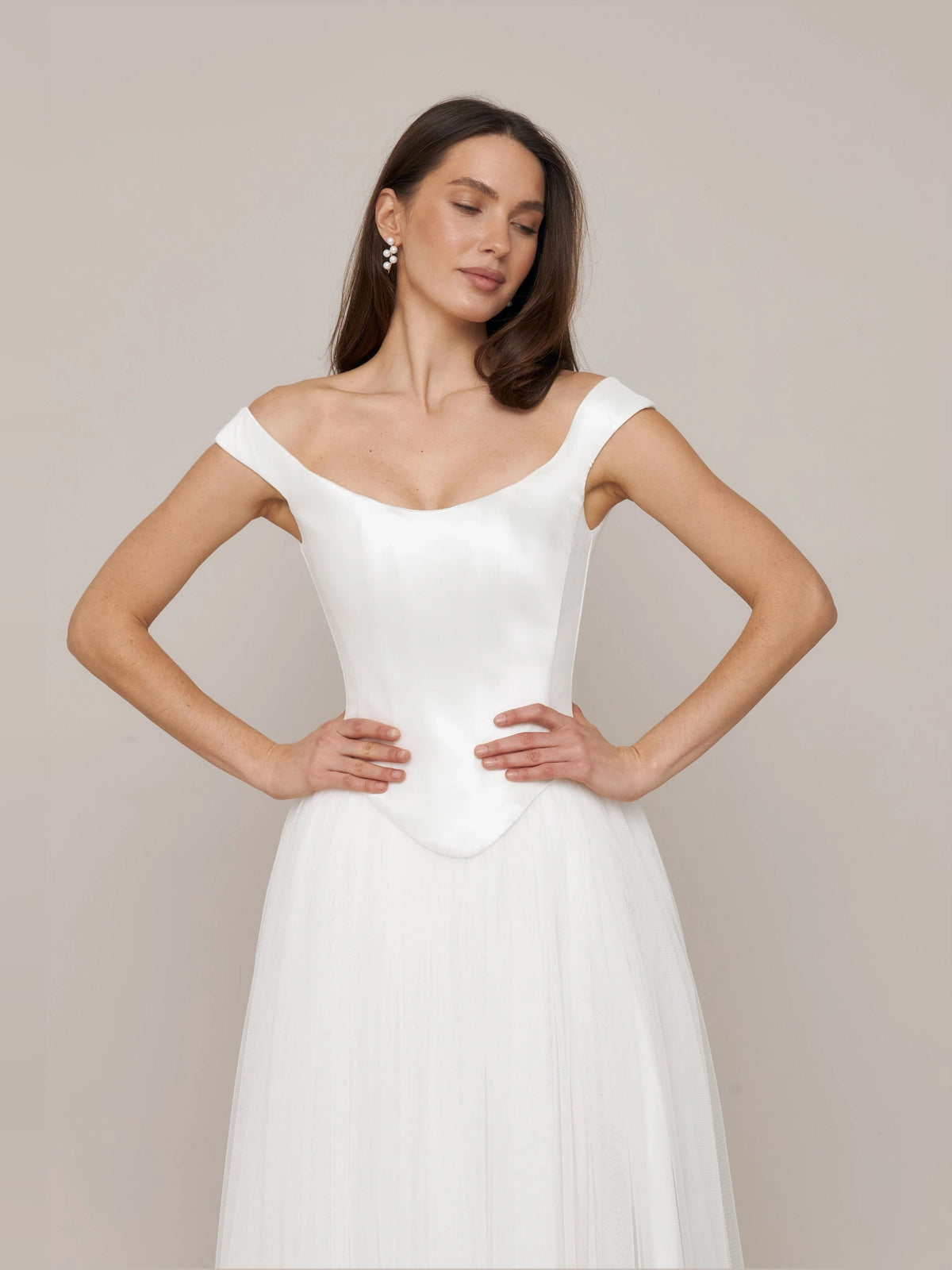 Ivory off-shoulder satin corset wedding dress with fitted bodice and A-line skirt
