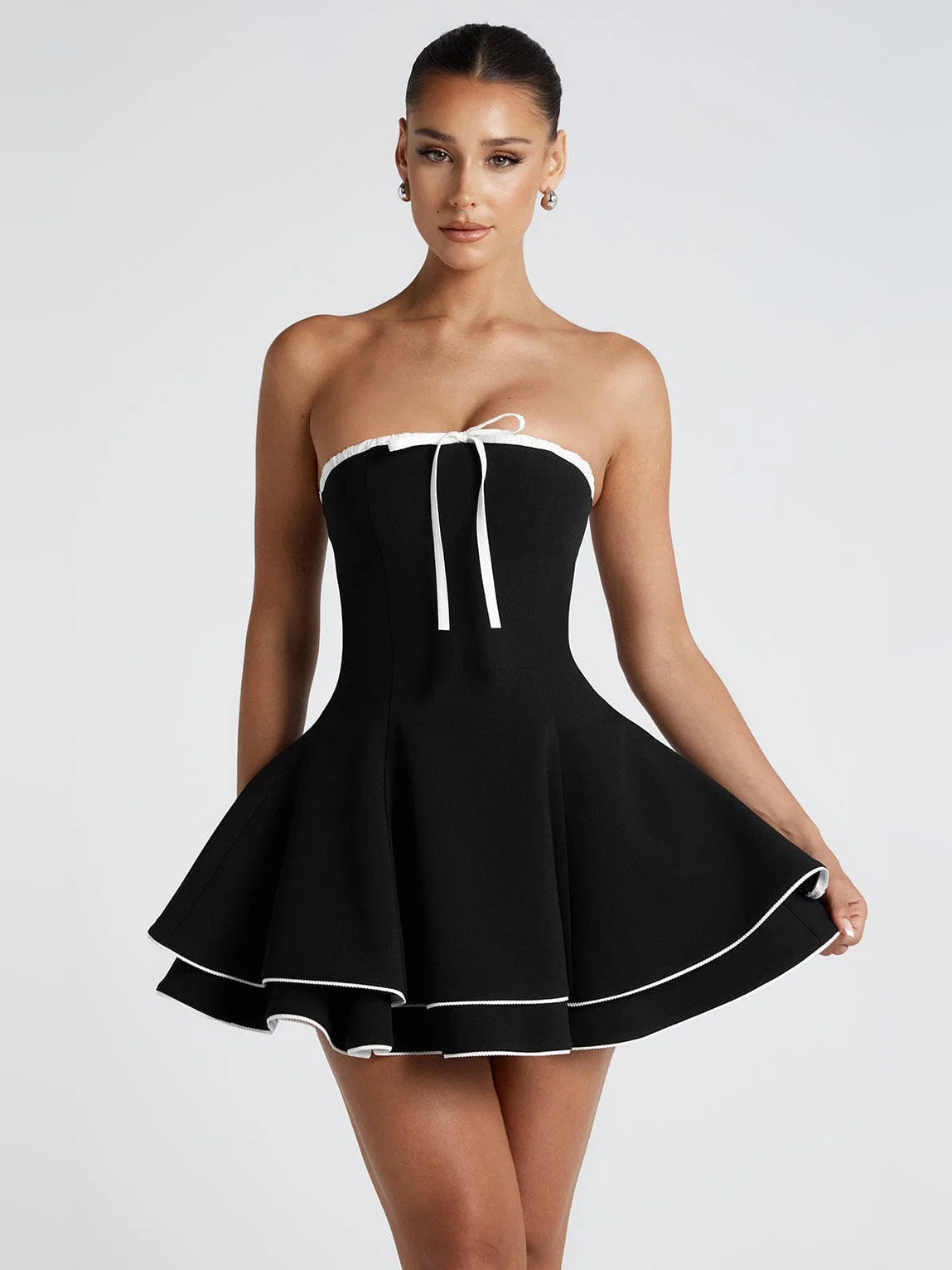 Mini homecoming dress: strapless black with white trim, ribbon tie at bust, A-line flare