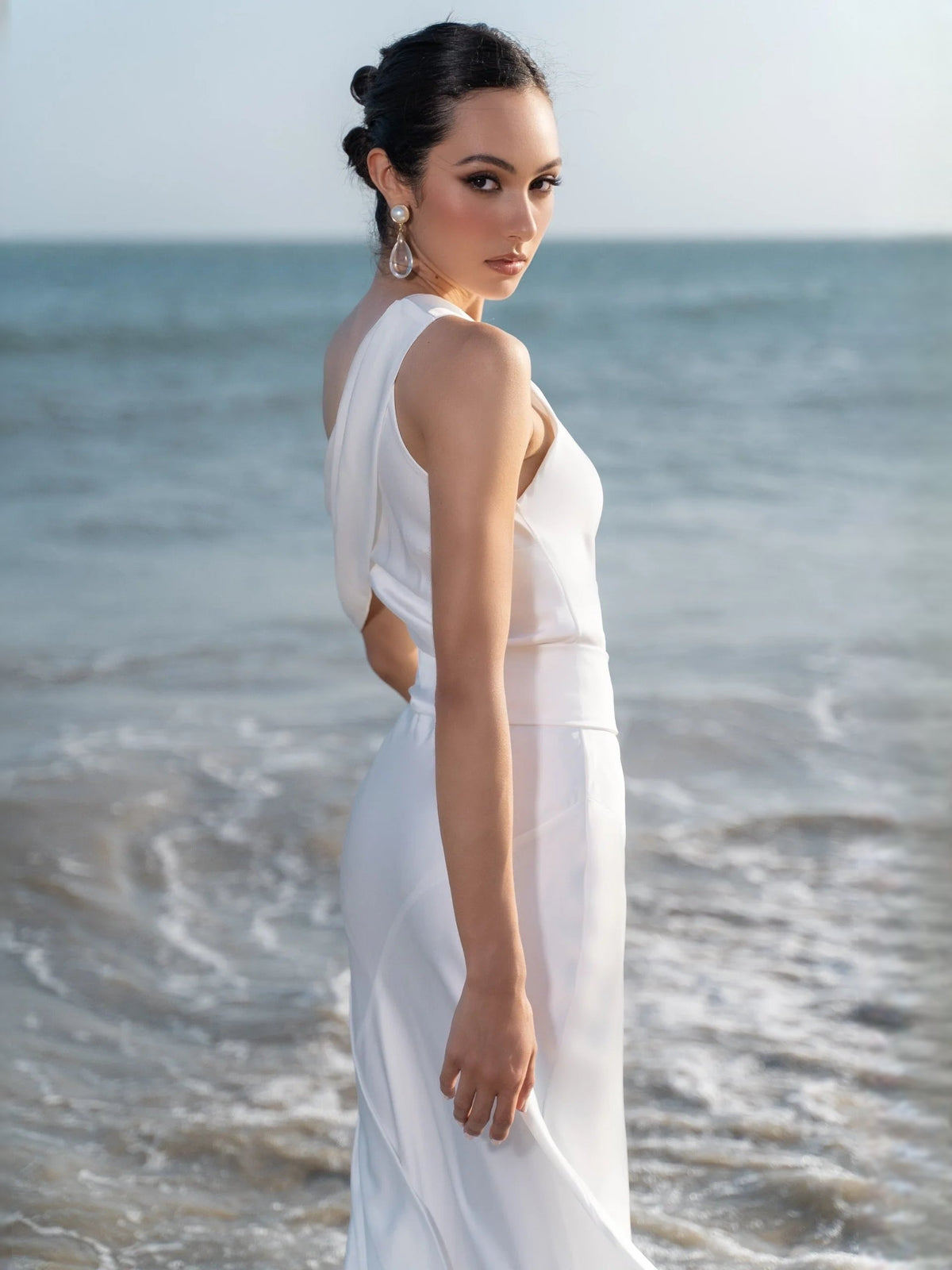 White satin sheath midi dress with halter back drape and fitted side seam