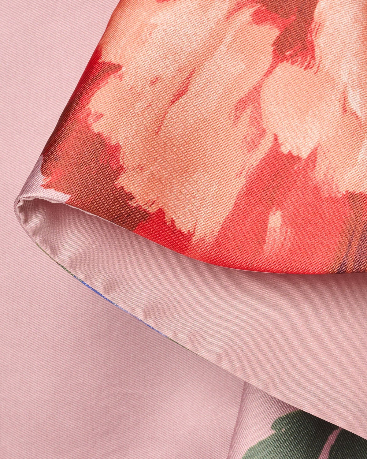 Mauve floral print draped fabric with coral and green flower motifs