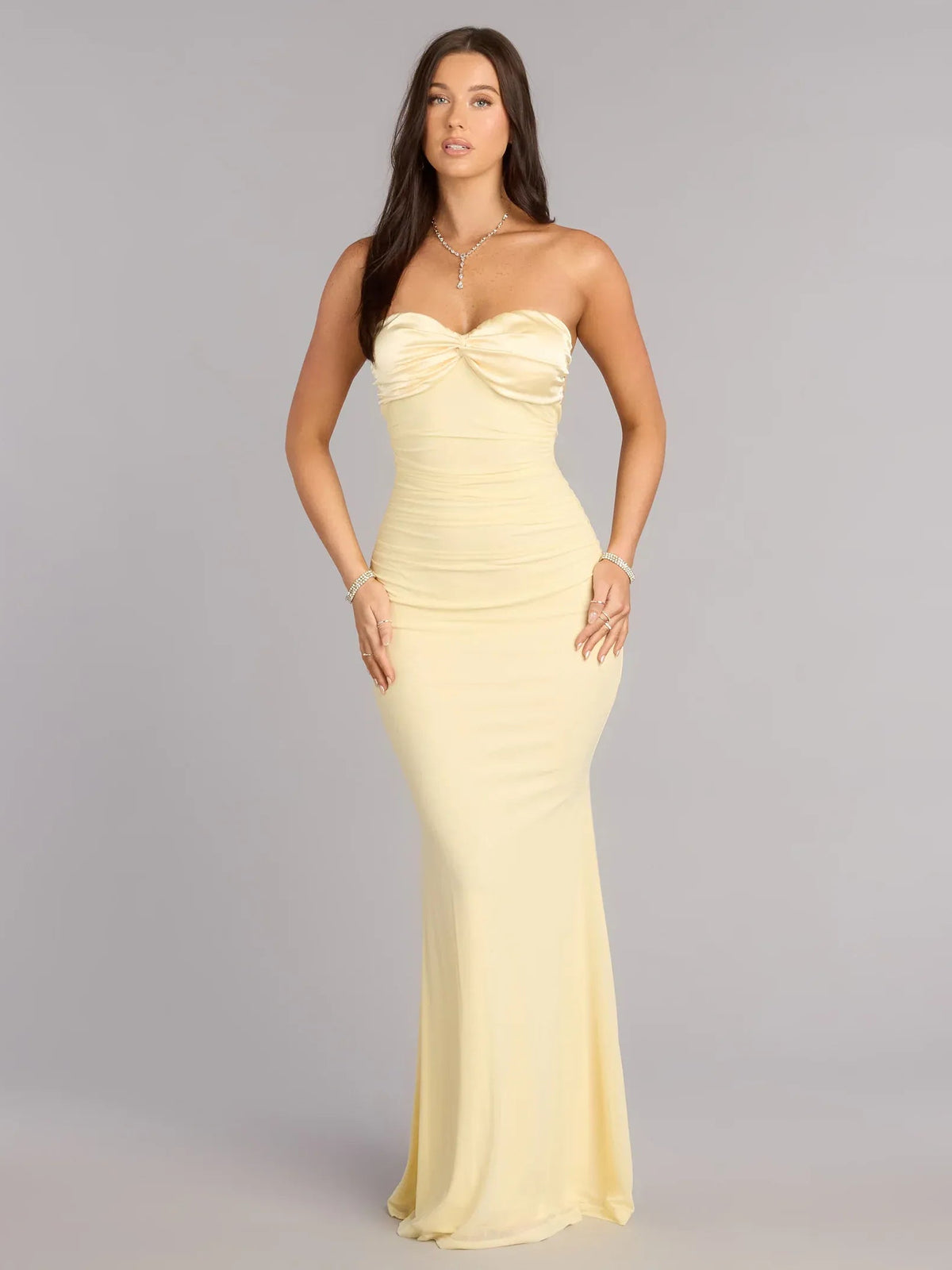 Light yellow strapless floor-length dress with ruched bodice and sweetheart neckline