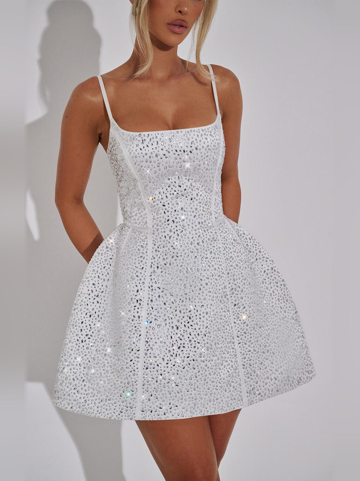 White sequin bodice with spaghetti straps and square neckline on mini dress