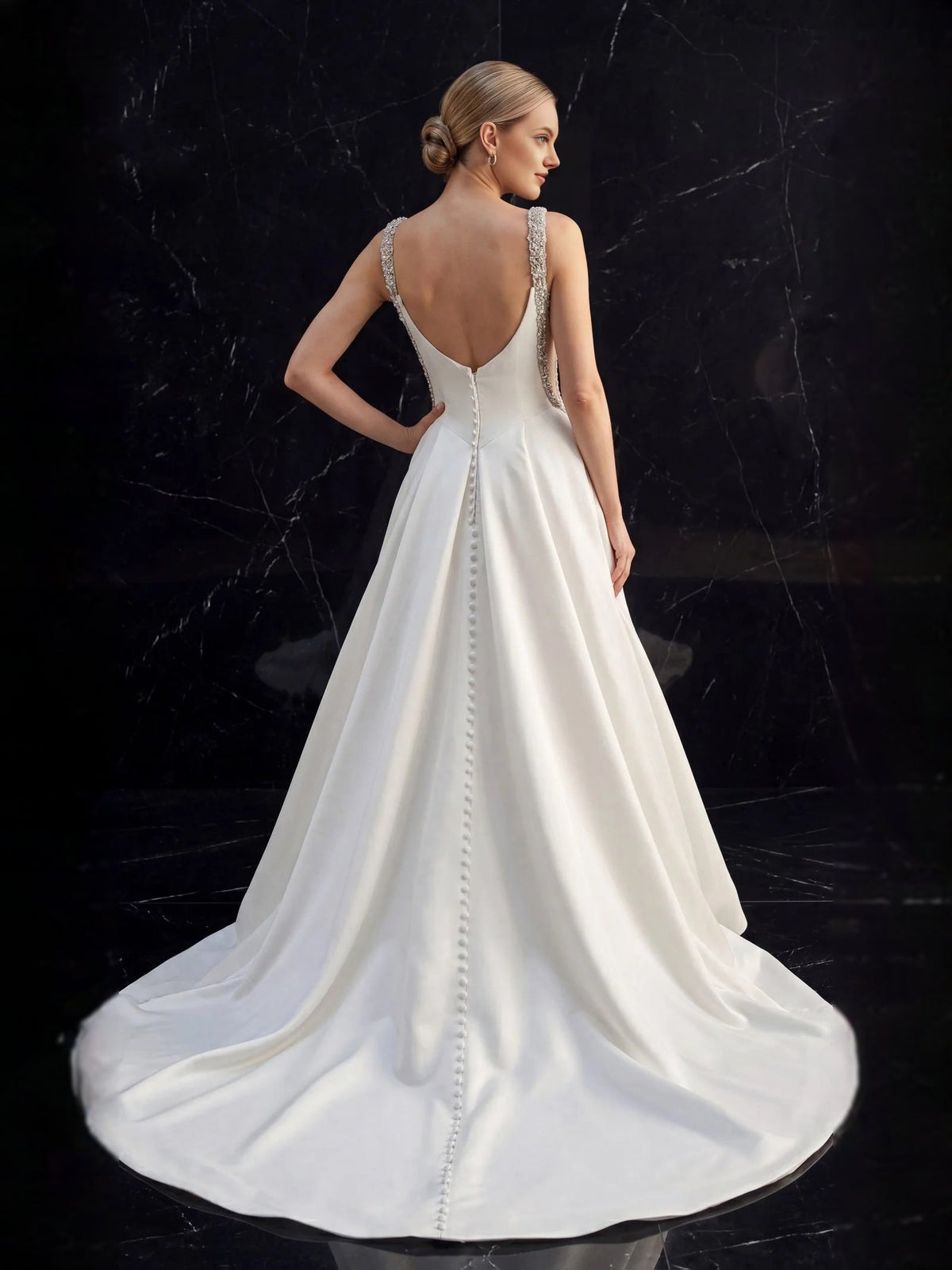 White satin A-line wedding dress with open back and beaded crystal straps