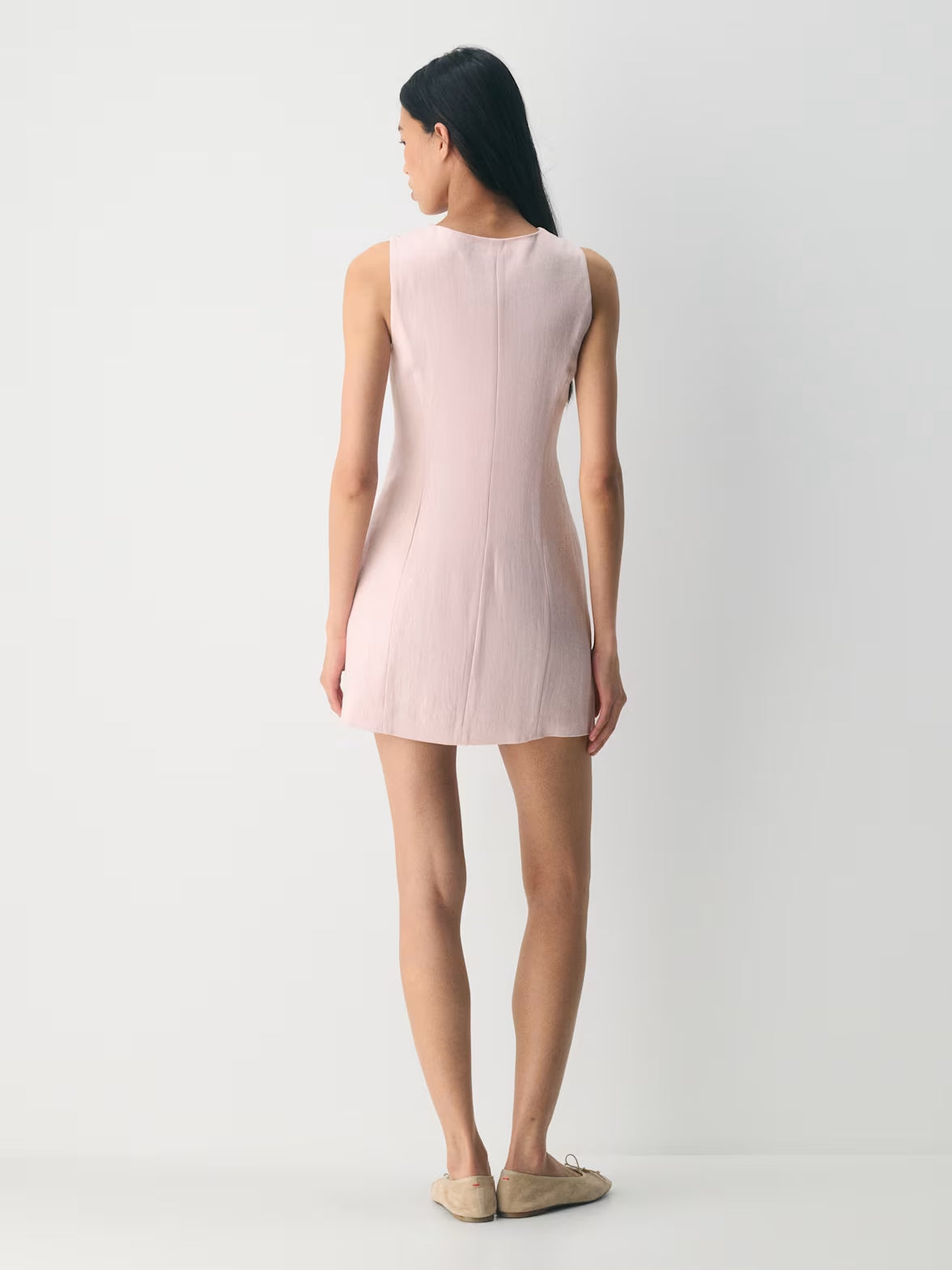 Light pink sleeveless mini dress with V-shaped back, back view