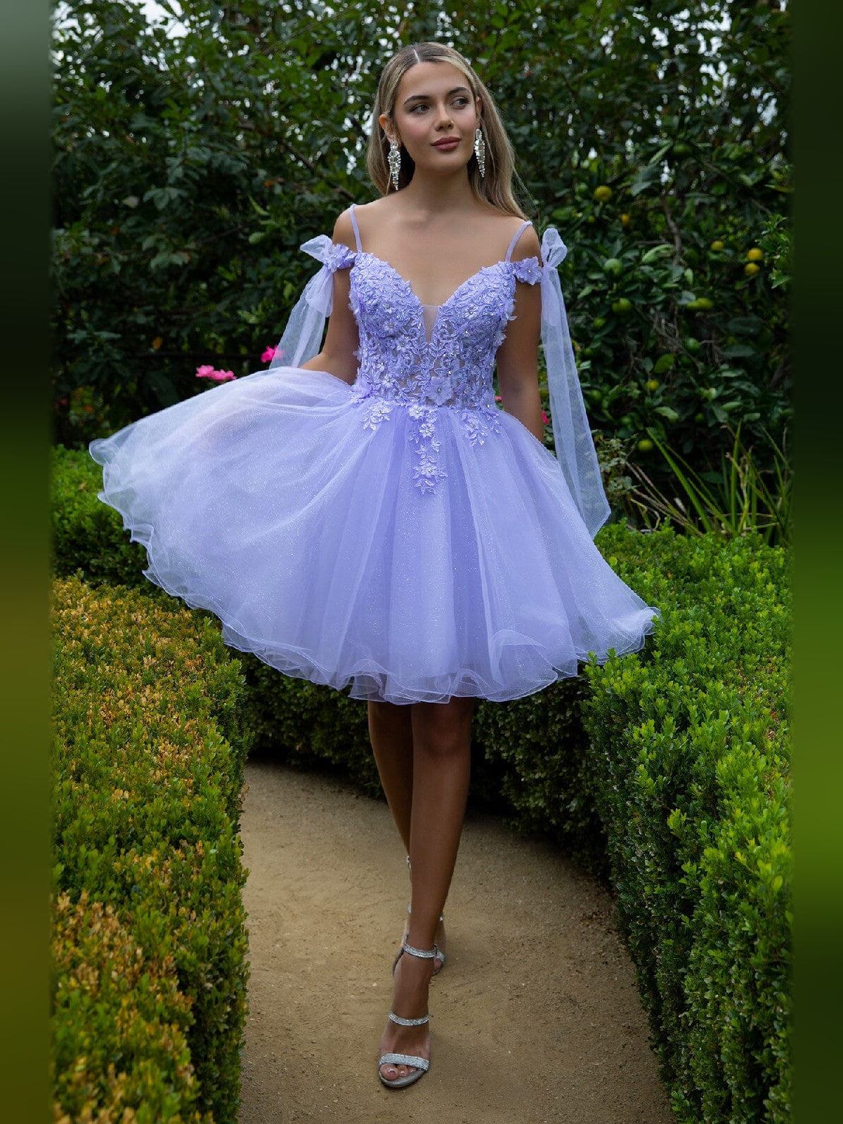 Short lilac tulle homecoming dress with floral appliqué, V-neck and bow straps