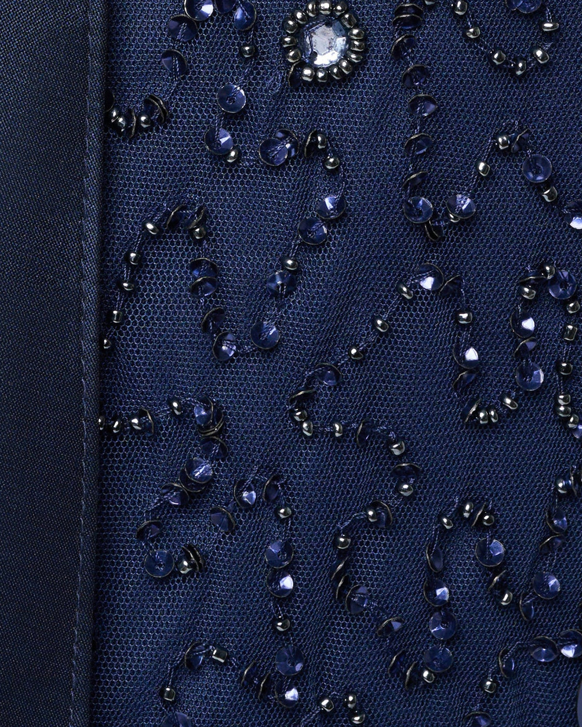 Light navy sequin fabric close-up with reflective beads and rhinestone-like details