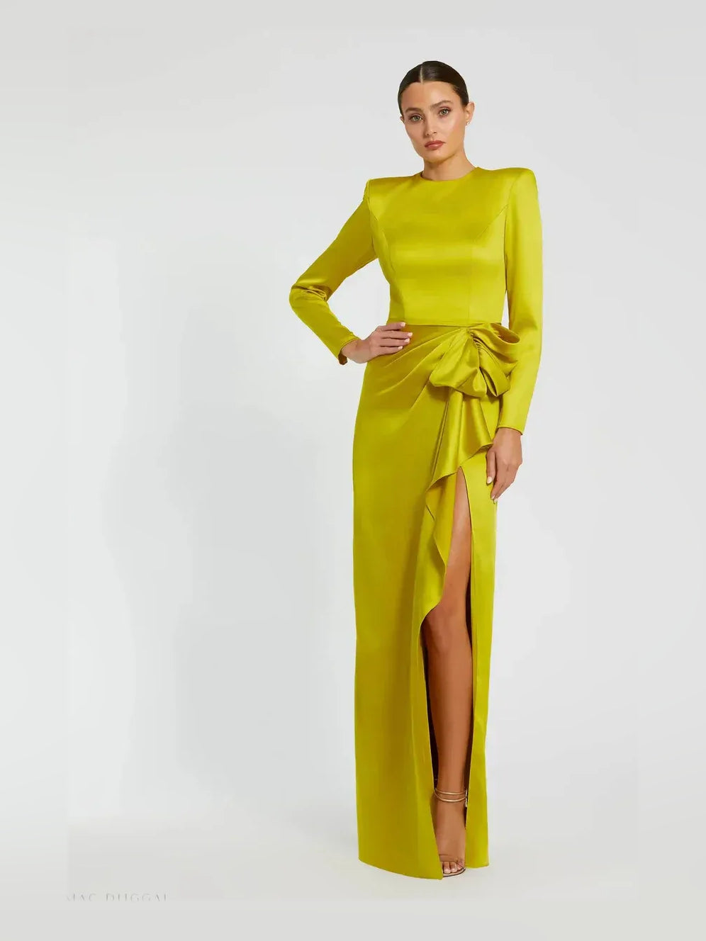 Floor-length formal dress in chartreuse, long sleeves, waist ruffle detail, leg slit