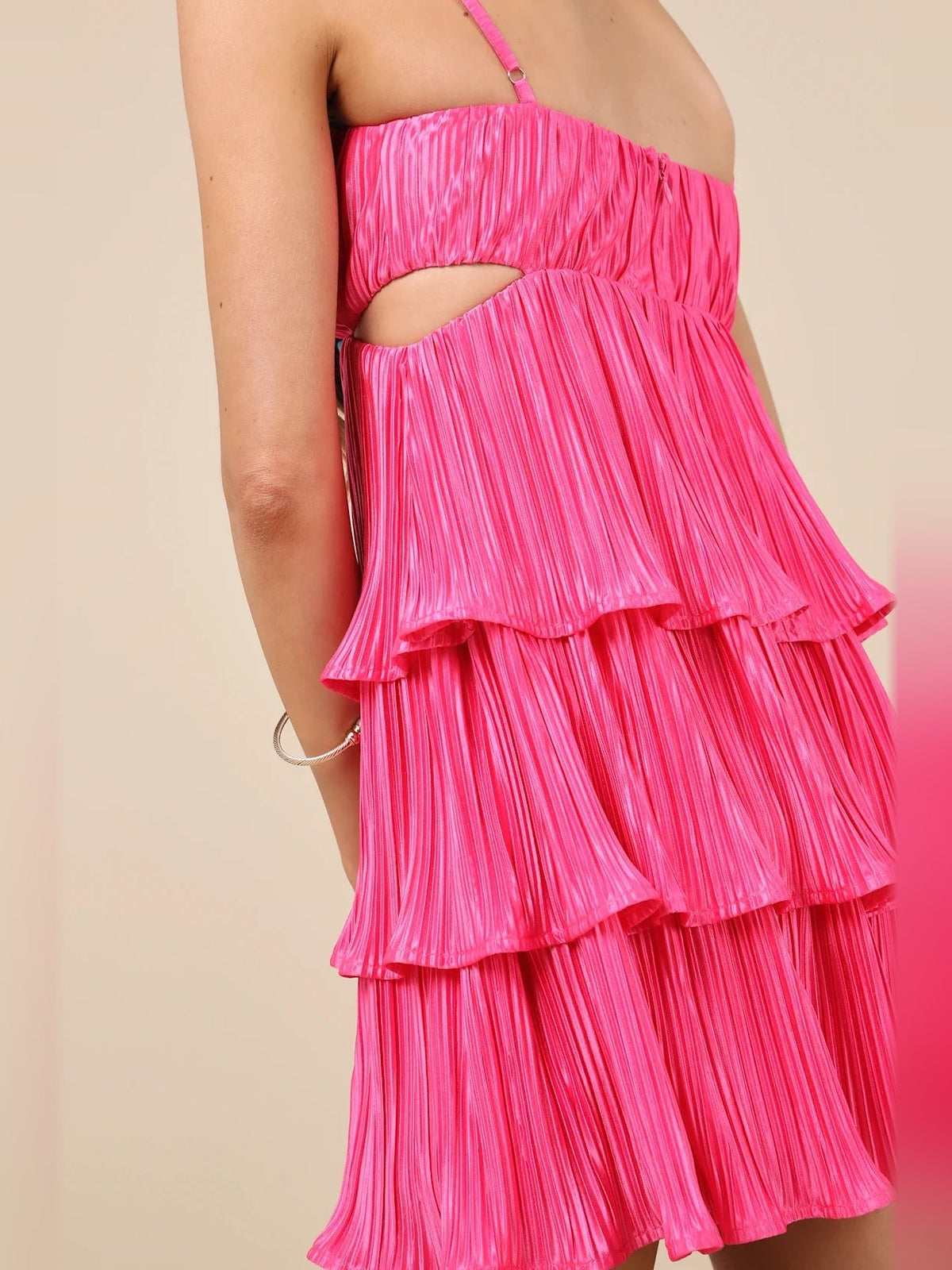 Pink satin mini dress with side cut-out and tiered ruffle skirt close-up