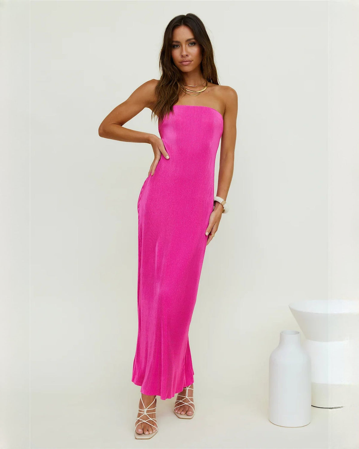 Pink strapless satin maxi dress with A-line shape and subtle side slit