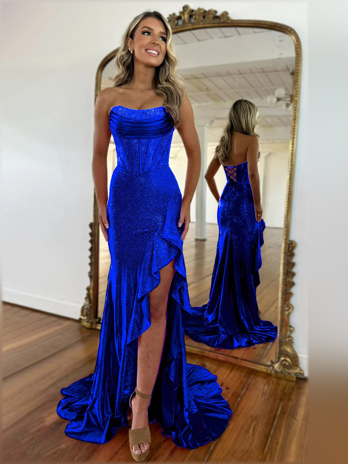 Royal blue strapless mermaid formal dress with glittery fabric and front leg slit.