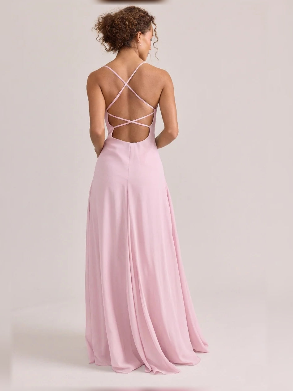 Pink maxi chiffon bridesmaid dress, open-back crisscross straps and front slit.