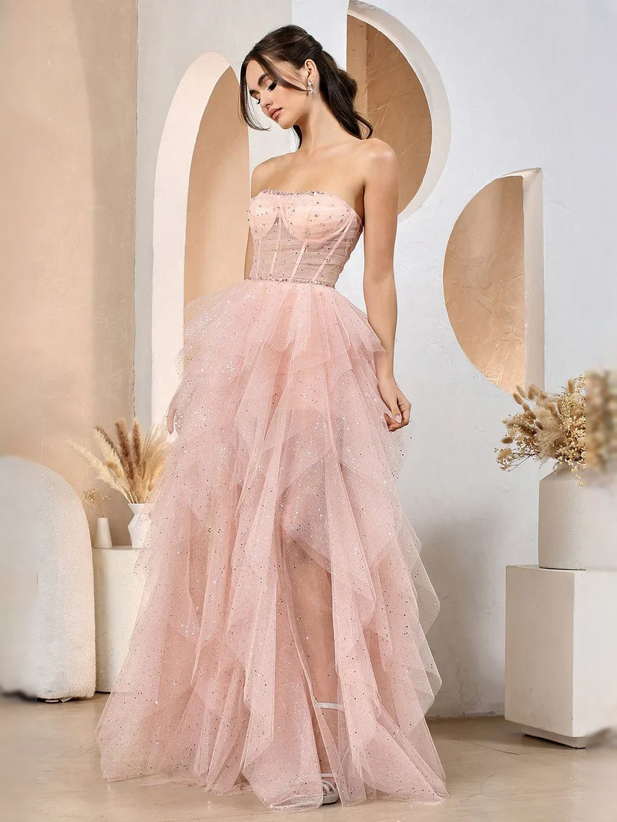 Blush pink strapless corset prom dress with ruched bodice and full A-line tulle skirt