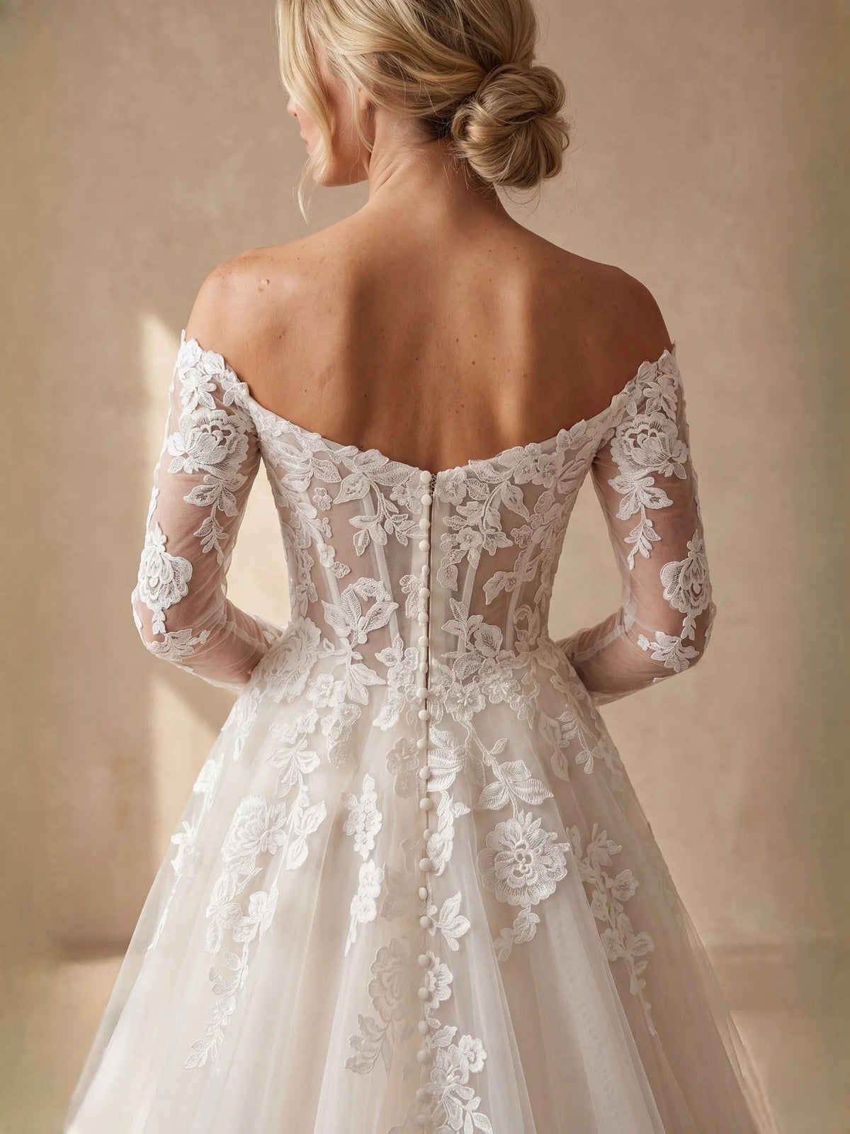 Ivory off-shoulder lace corset wedding dress with long sleeves and floral tulle skirt