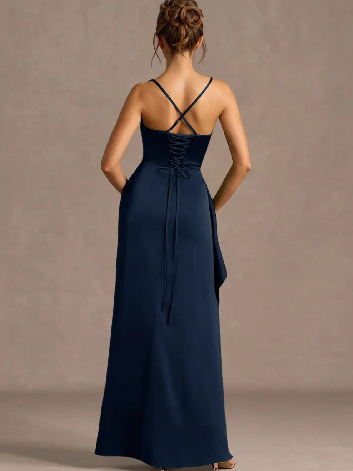 Back view: dark navy formal dress with crisscross spaghetti straps and long slit skirt.