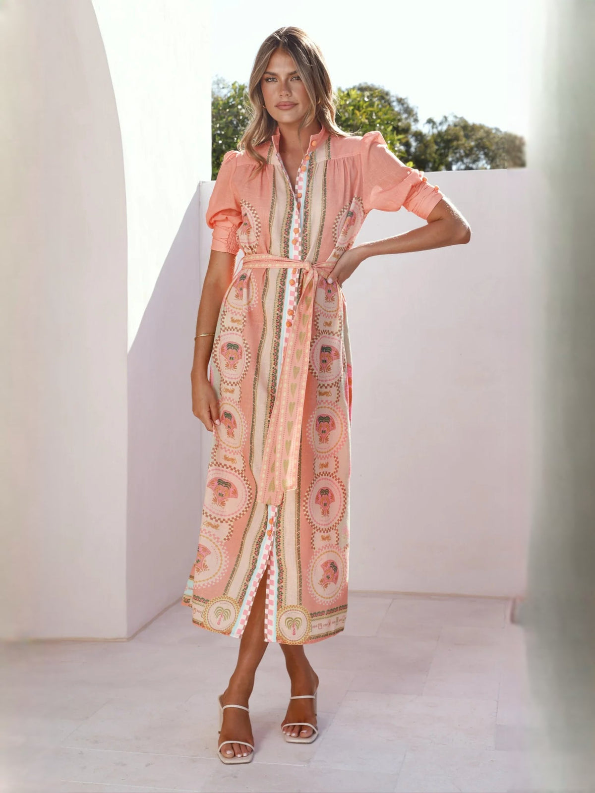Peach midi formal dress with medallion print, waist tie, and short puff sleeves