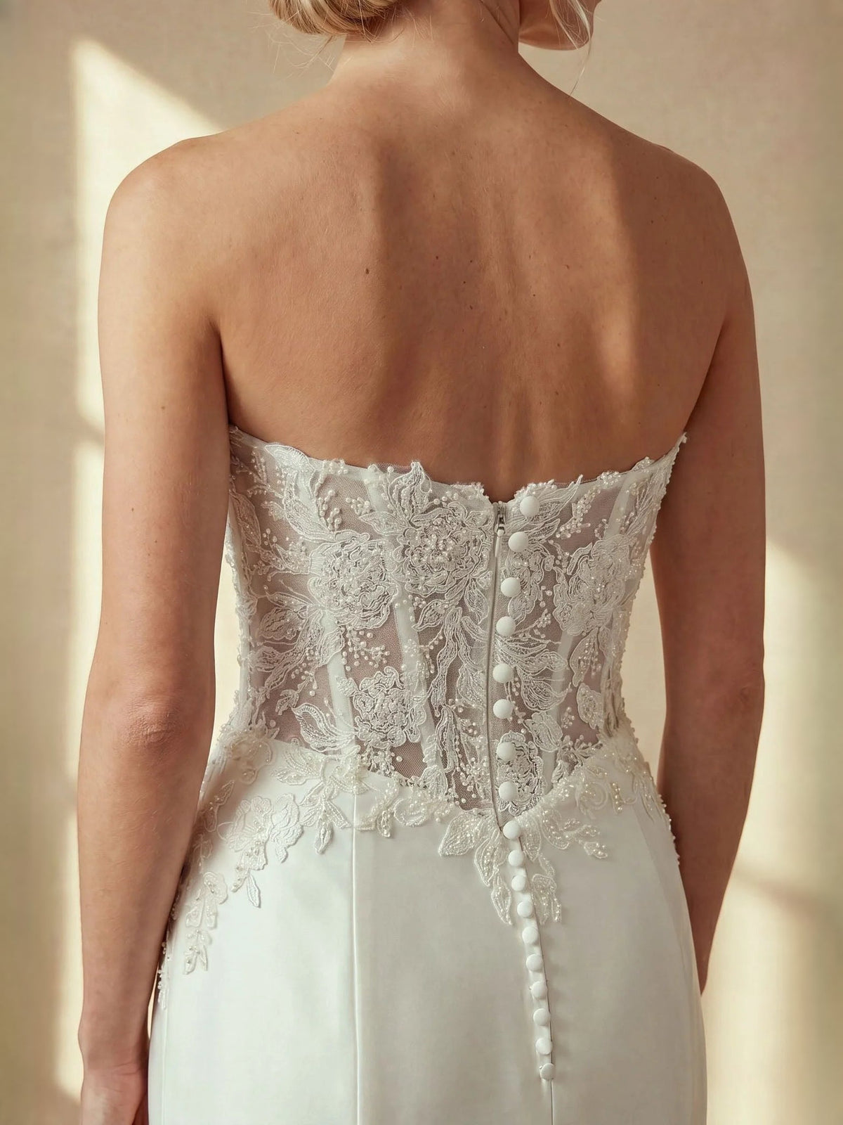 Ivory strapless mermaid wedding dress with lace corset back and button closure