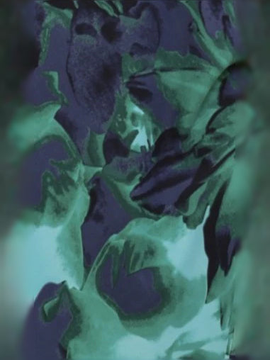 Close-up of teal and purple floral leaf print fabric.