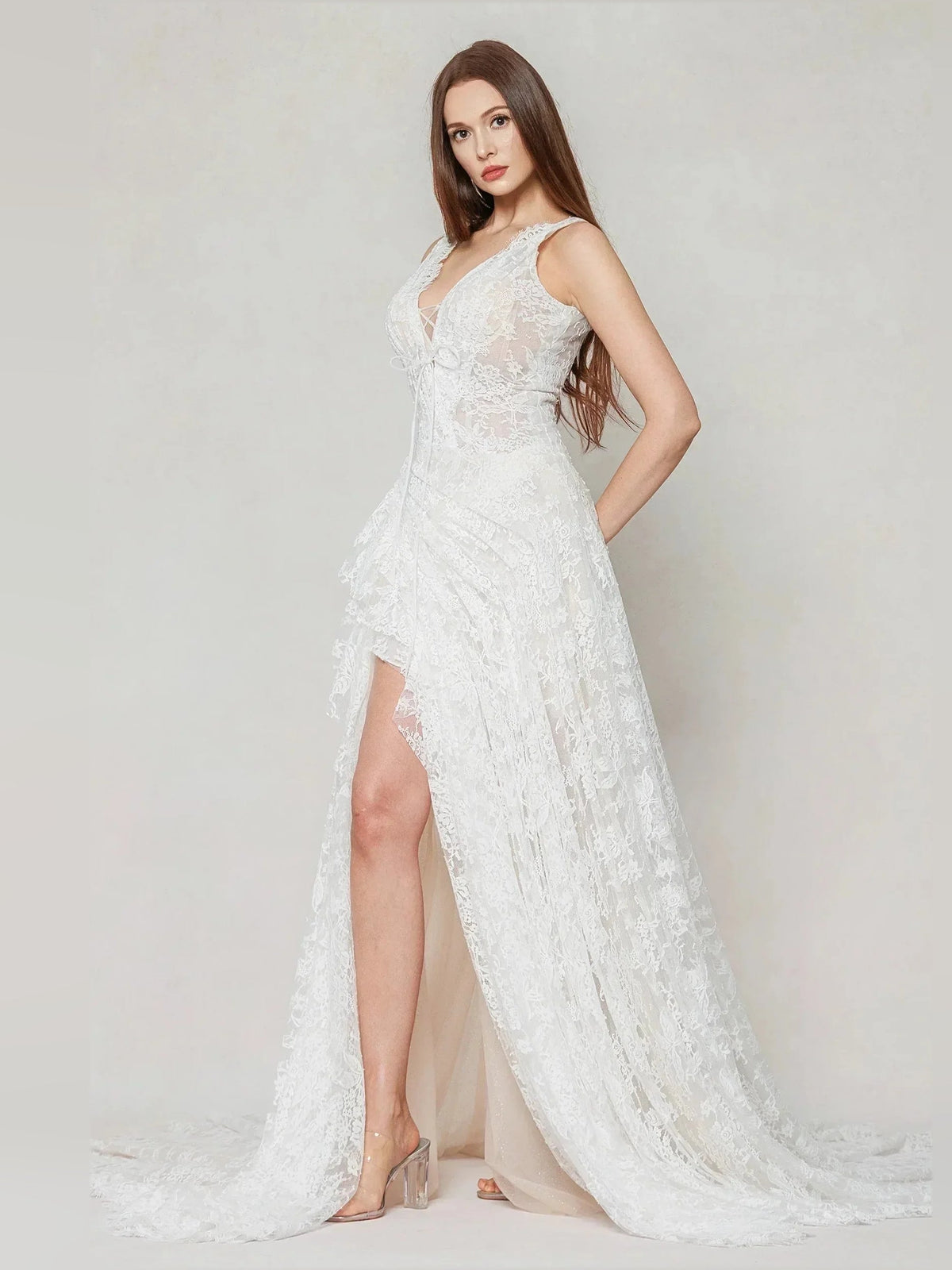 Ivory sleeveless lace wedding dress with V-neck, side slit, flowing floor-length skirt