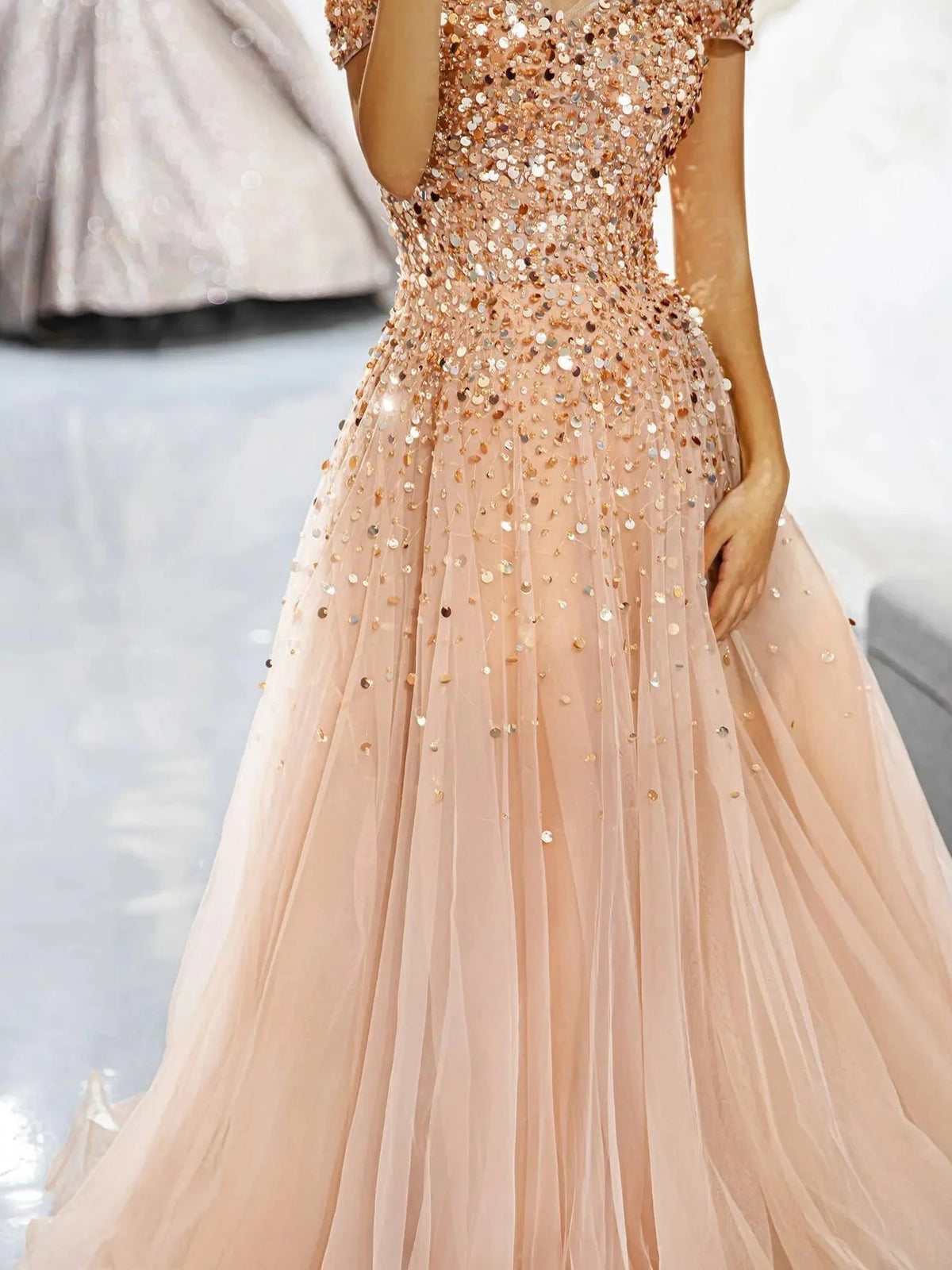 Champagne sequined corset dress with ruffled off-shoulder and pleated tulle skirt