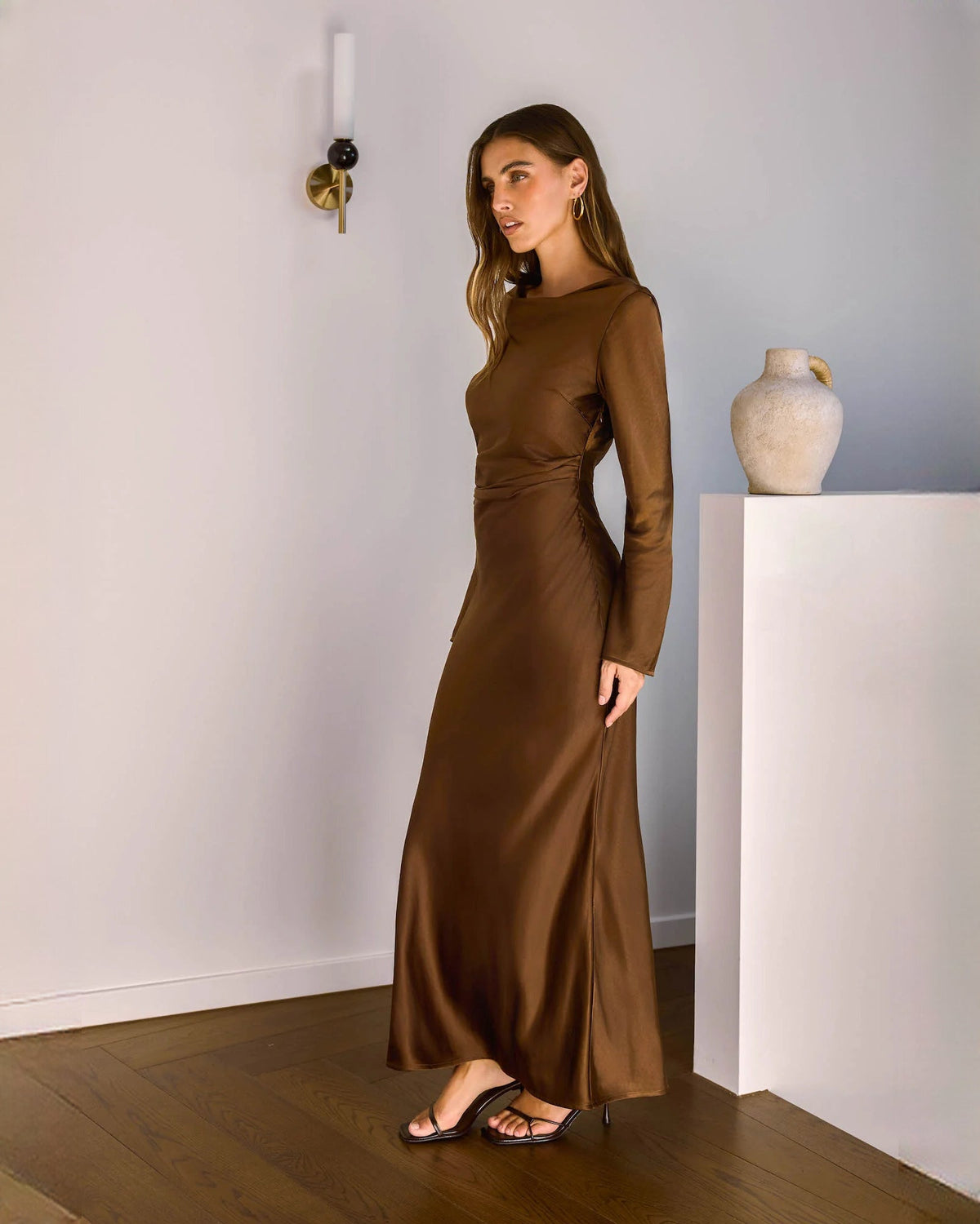 Chocolate brown satin long-sleeve maxi dress with bateau-style neckline and tapered fit