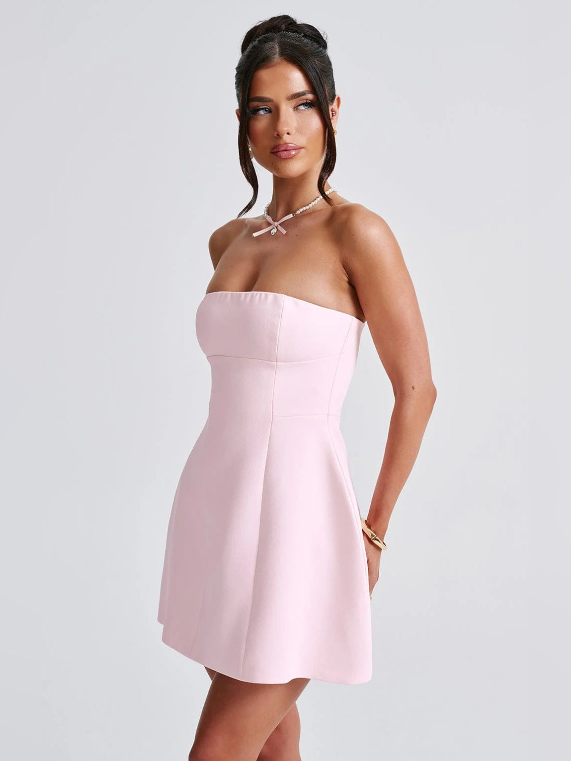 Blush strapless fit-and-flare mini dress with fitted waist and angled skirt shape