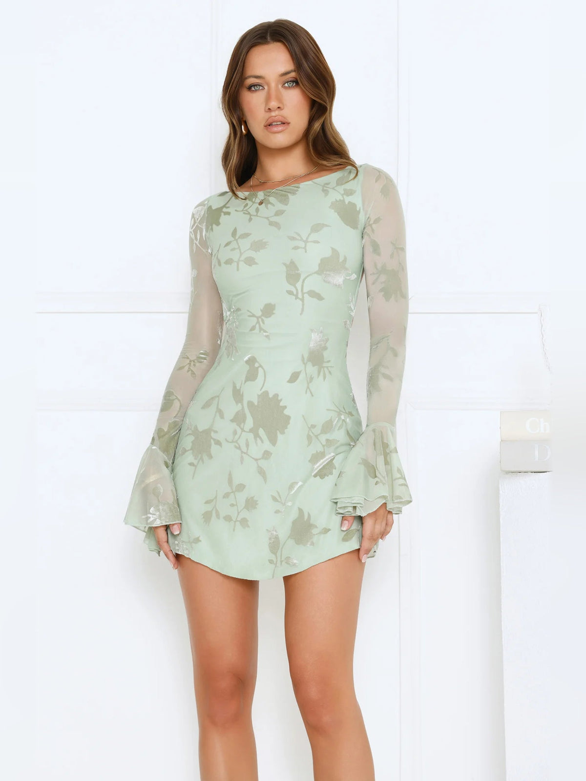 Sage green long-sleeve mini dress with floral print and flared bell sleeves