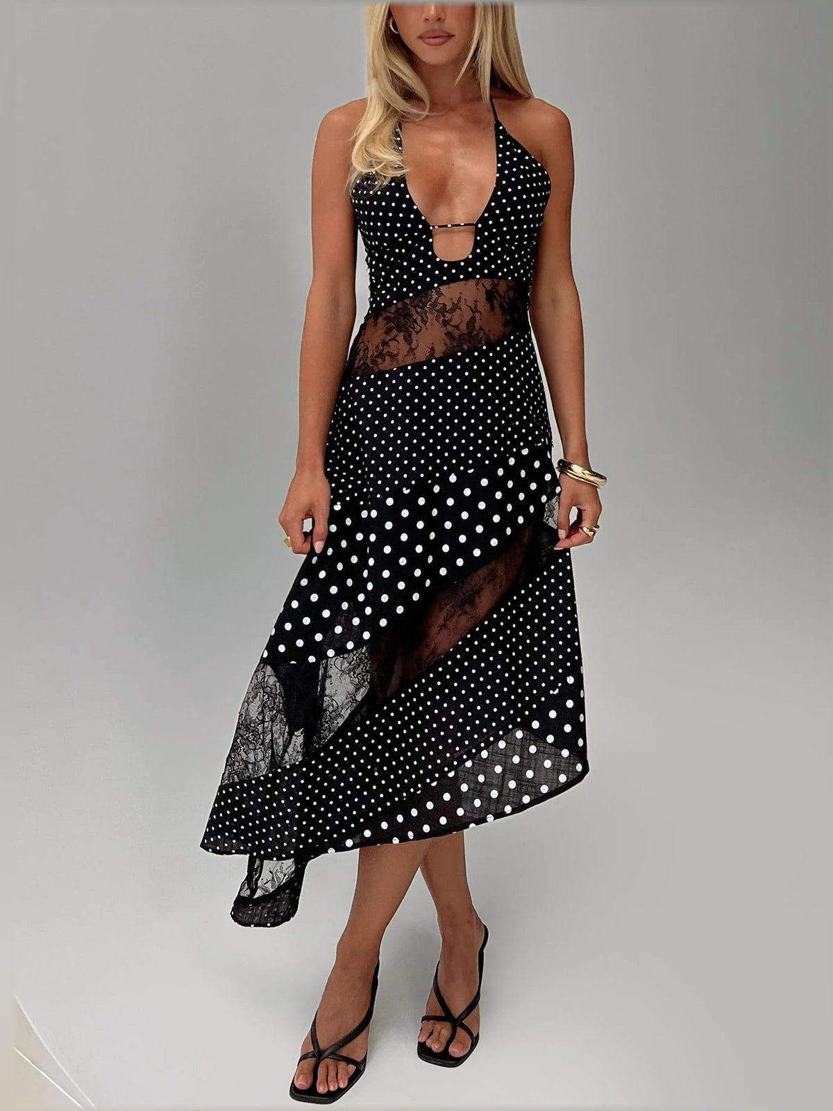 Black polka-dot asymmetrical midi dress with V-neck, sheer lace panels, and uneven hem