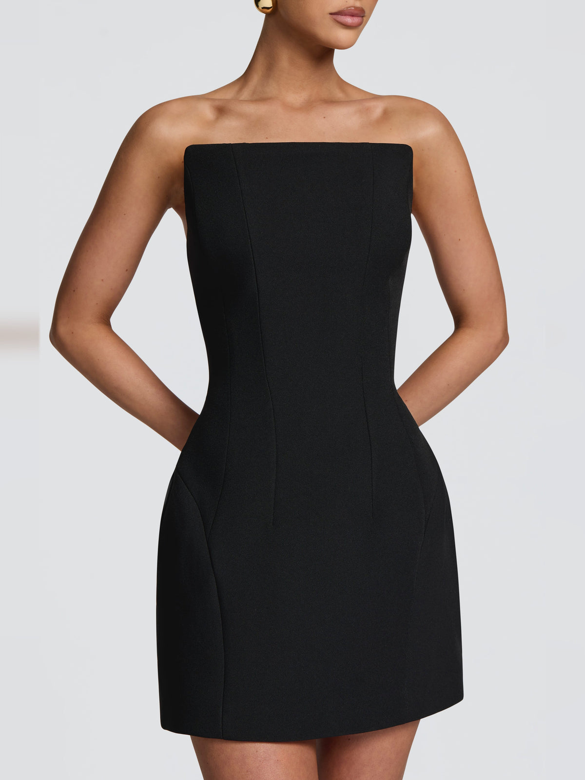 Black strapless mini dress close view with fitted corset-style seams