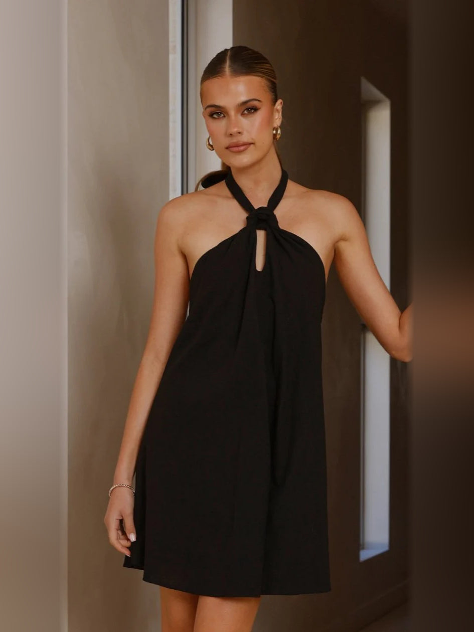 Black halter mini dress with tie-neck keyhole and flowy A-line skirt