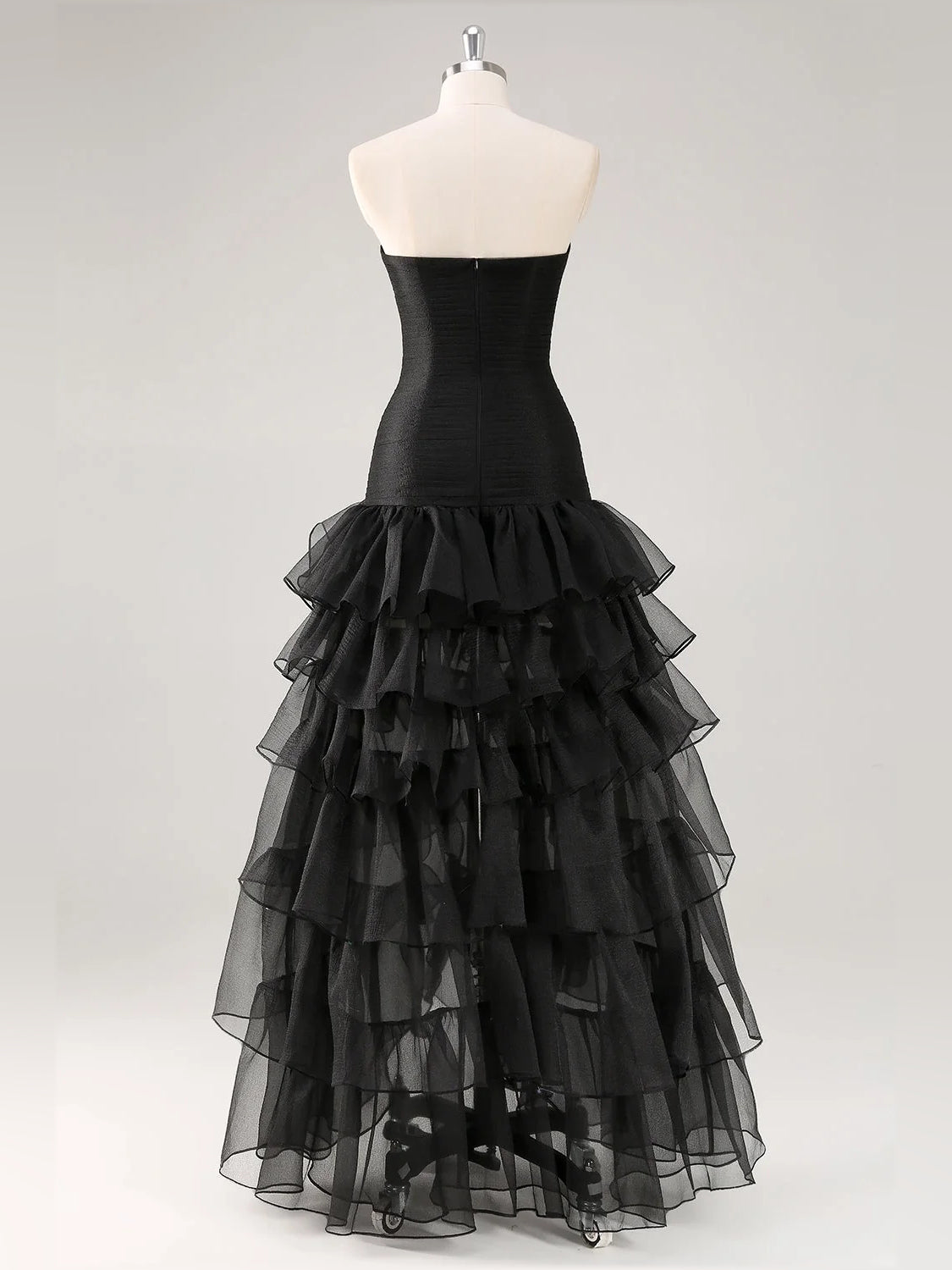 Black strapless tulle prom dress on mannequin with tiered ruffle skirt
