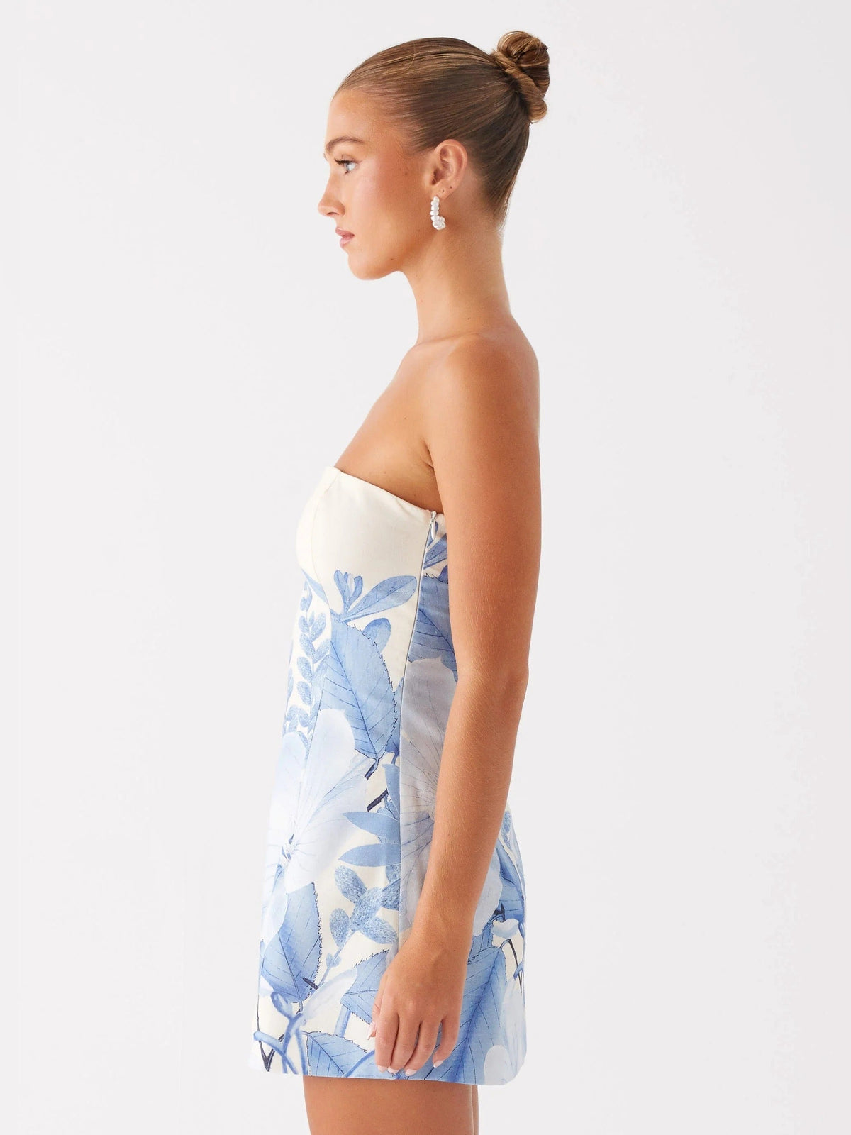 Blue floral strapless mini homecoming dress, side profile with short flared hem