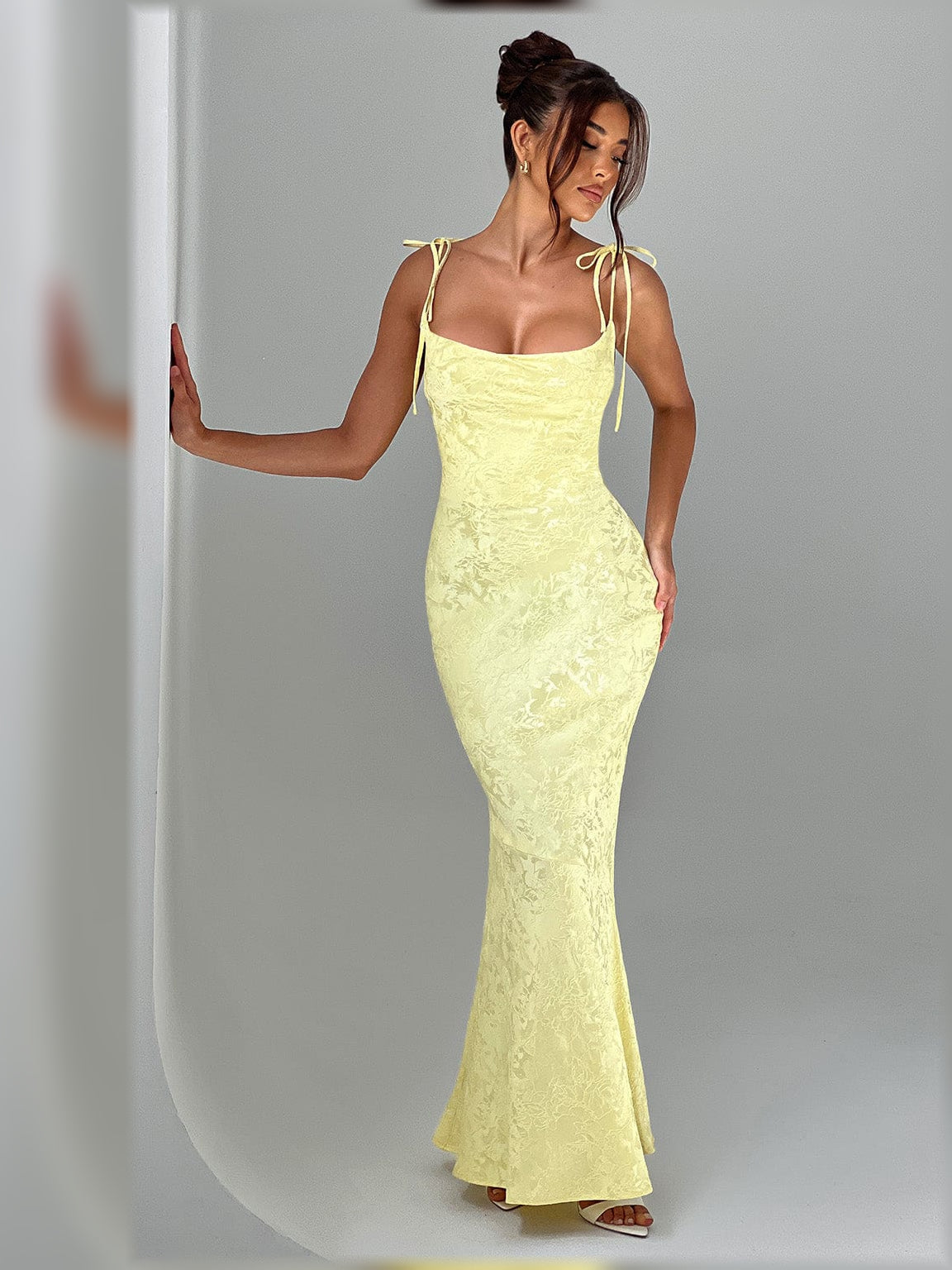 Pale lemon yellow floral formal dress with thin spaghetti straps and lace-up tie straps