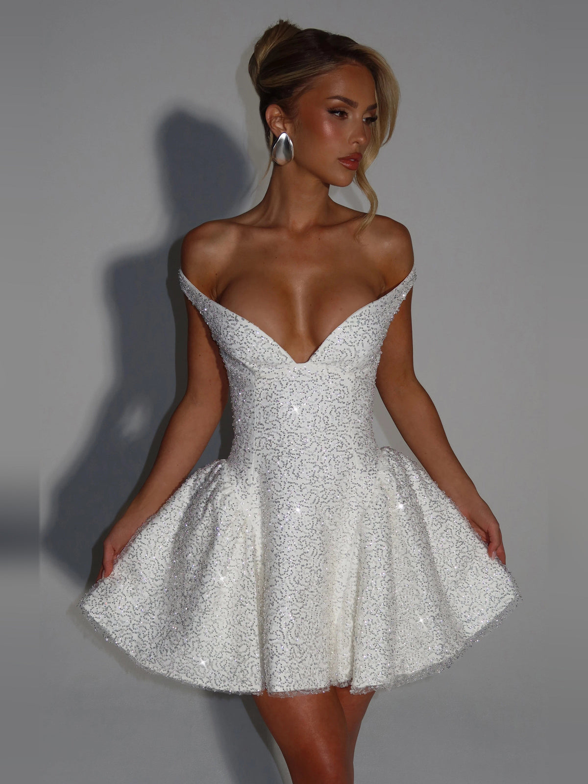 Ivory sequined mini dress with off-shoulder sweetheart neckline and flared skirt