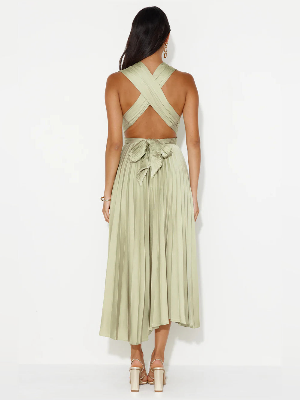 Back view of champagne midi formal dress with crisscross straps and ruffled waist detail