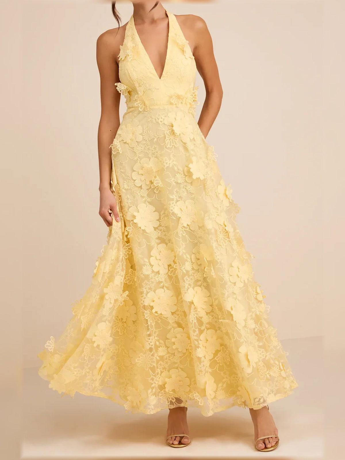 Yellow halter neck maxi formal dress with floral lace appliques and flowing skirt