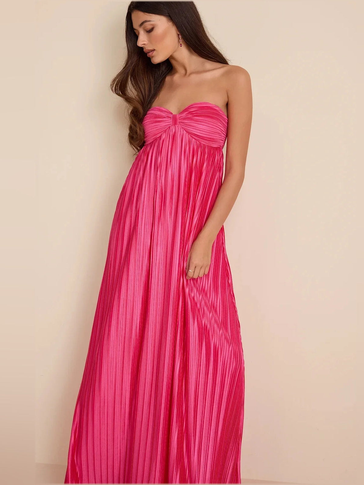 Hot pink strapless satin maxi dress with ruched bust and vertical pleated fabric