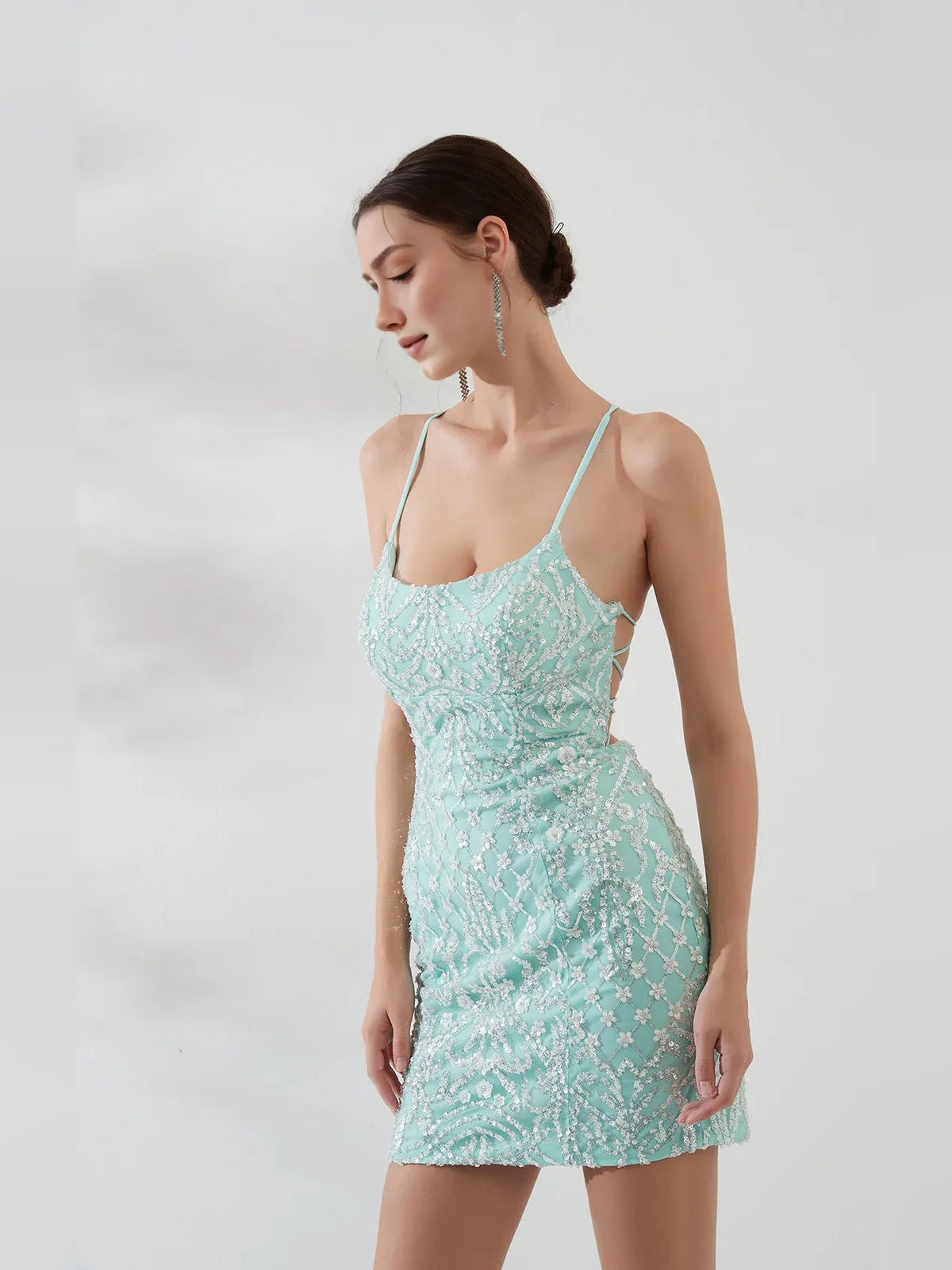 Mint green sequin mini homecoming dress with spaghetti straps and fitted silhouette