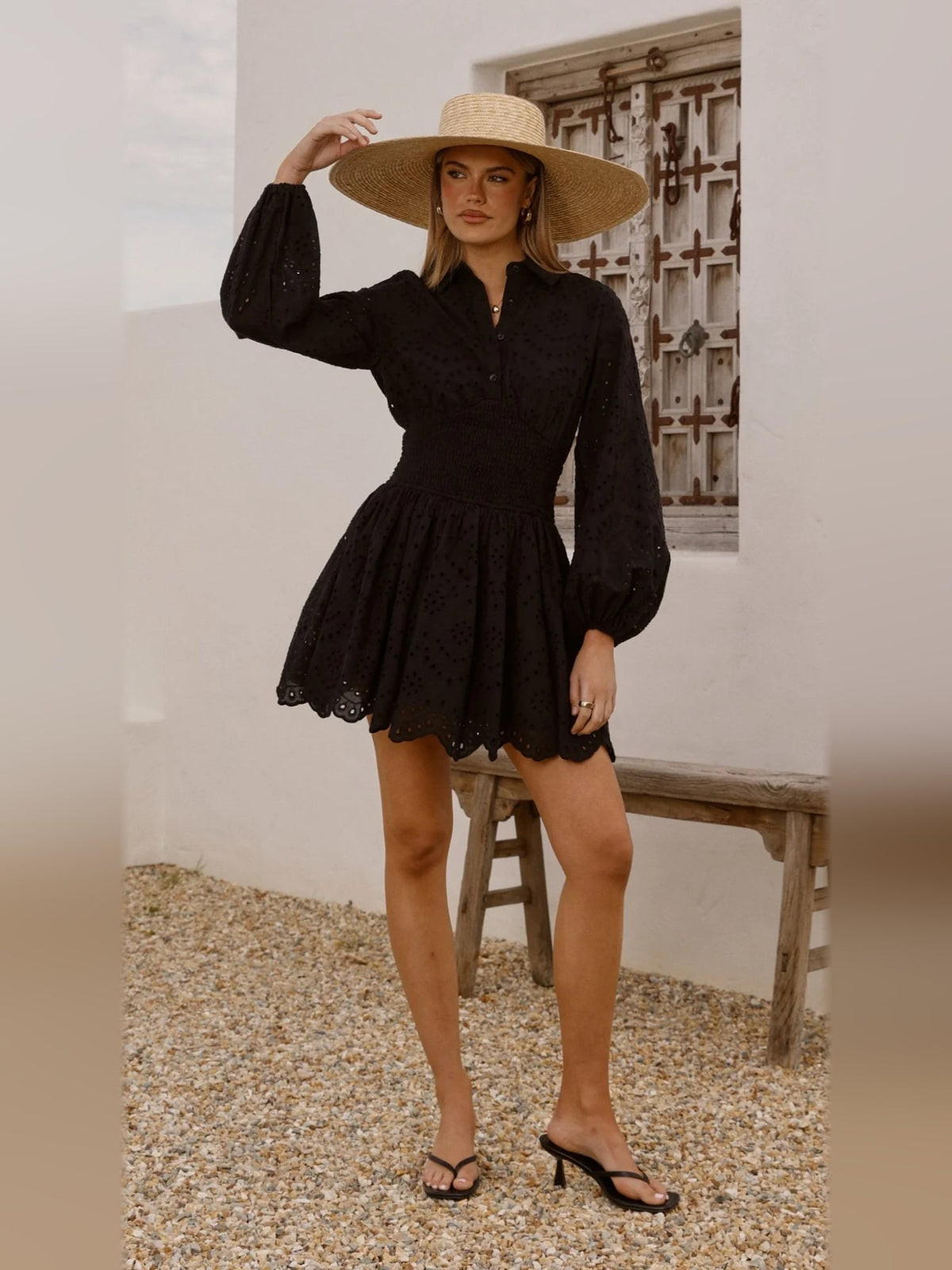 Black long-sleeve mini dress full body view, button placket, puff sleeves, scalloped hem