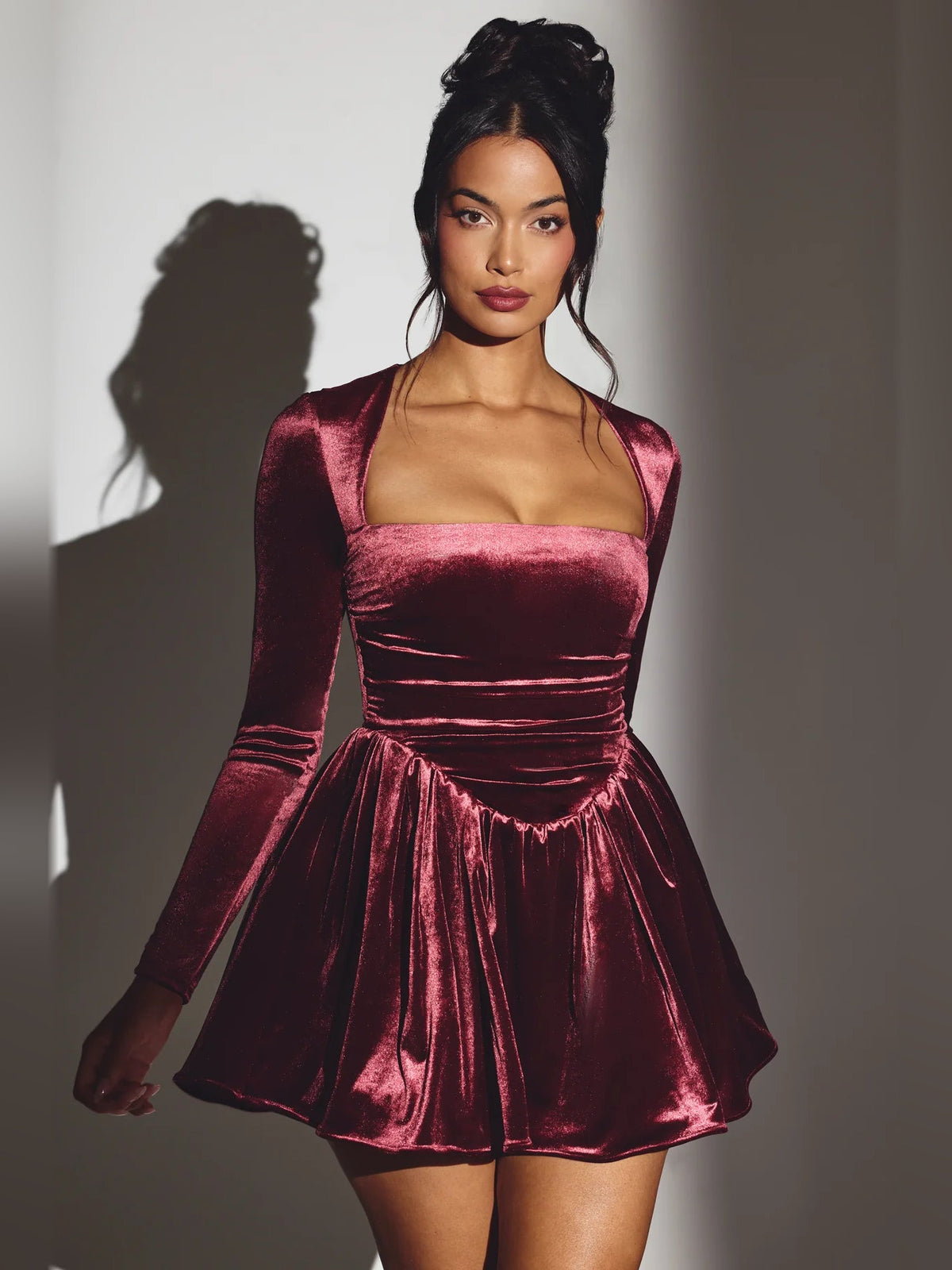 Wine velvet long-sleeve mini dress with square neckline and flared skirt, ruched waist.