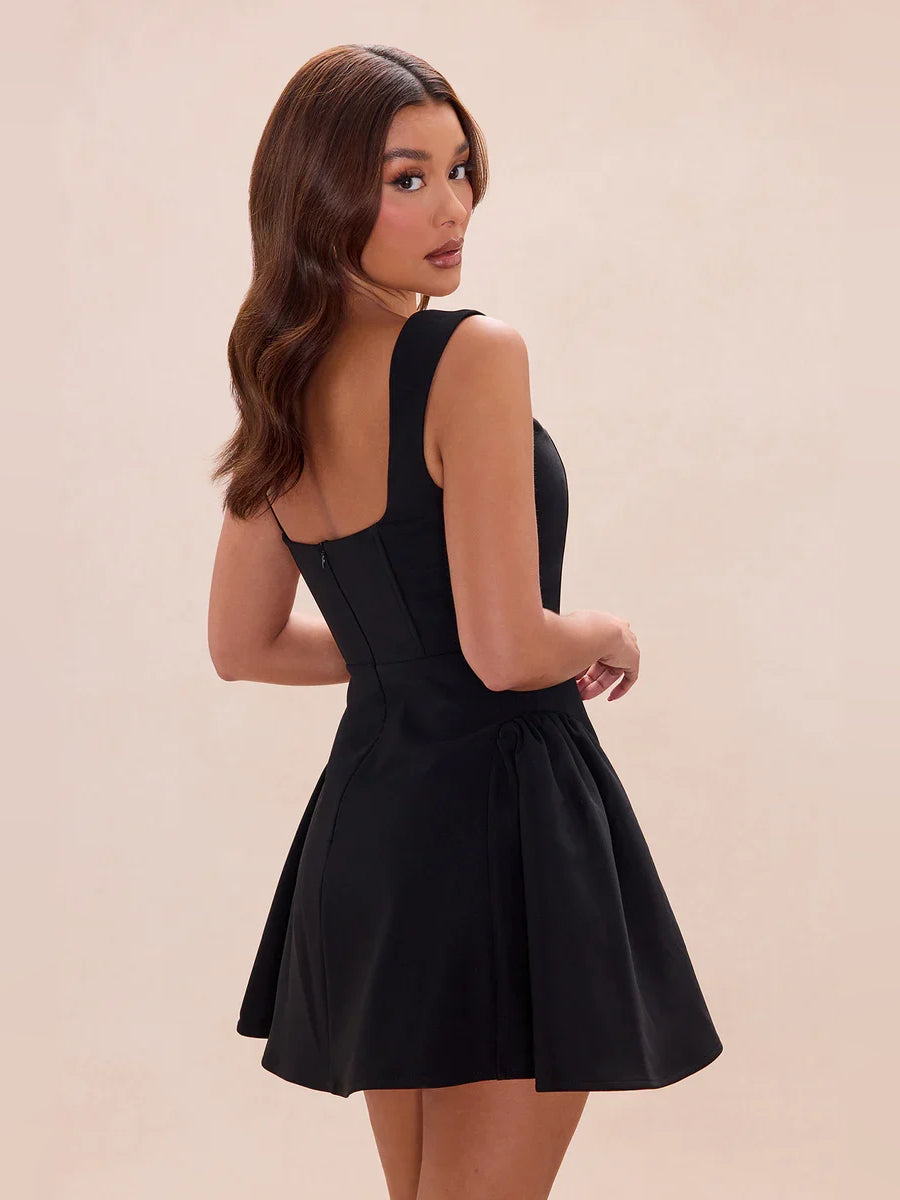 Black pleated square-neck A-line mini dress, sleeveless back view and flared skirt
