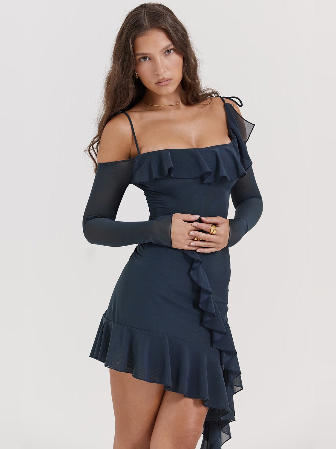 Navy off-shoulder mini dress with ruffled bodice, layered skirt, and sheer long sleeves